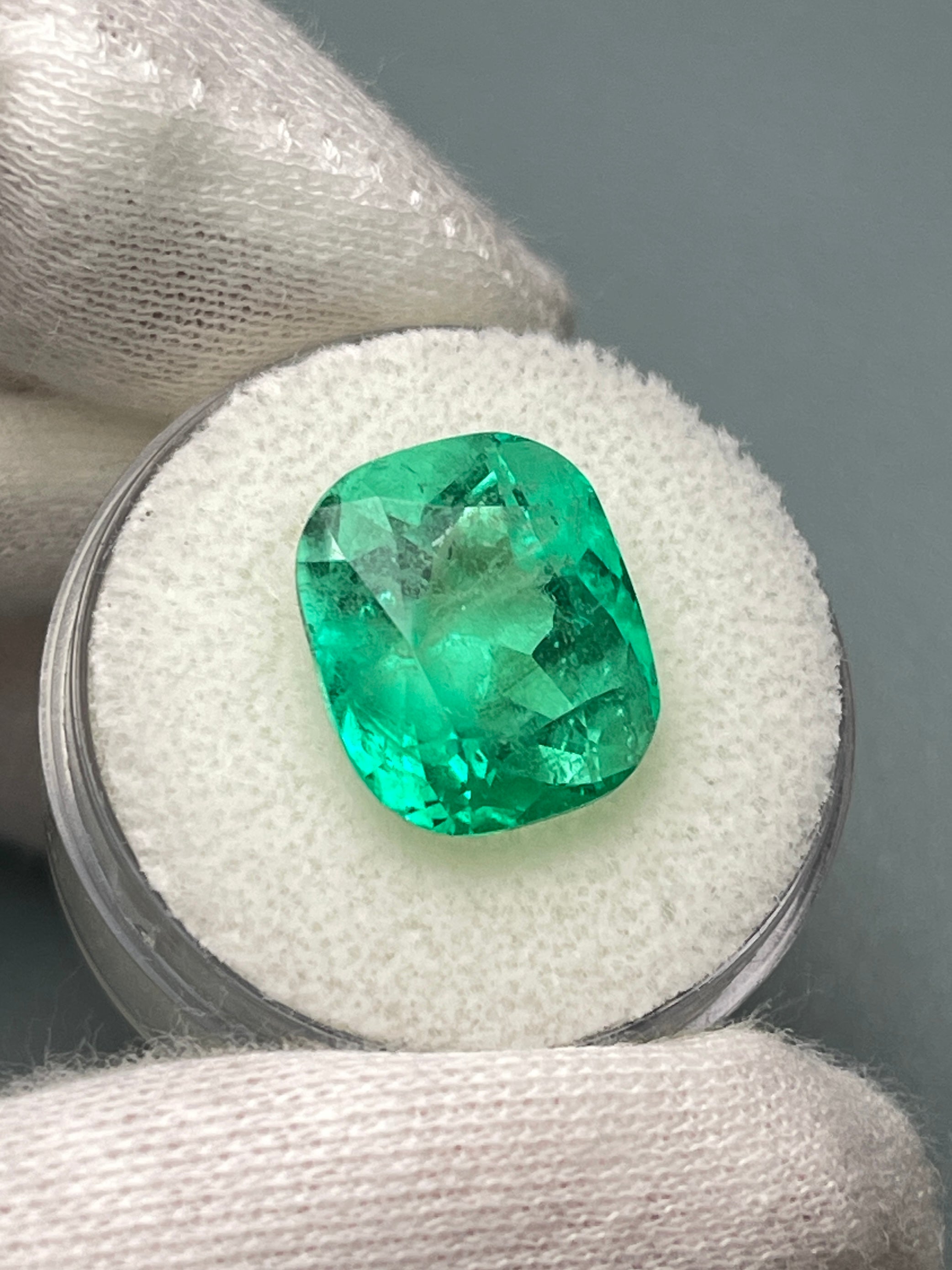 Natural loose Colombian emerald, 9.23 carats, cushion cut, yellowish green Muzo gemstone from JR Colombian Emeralds.