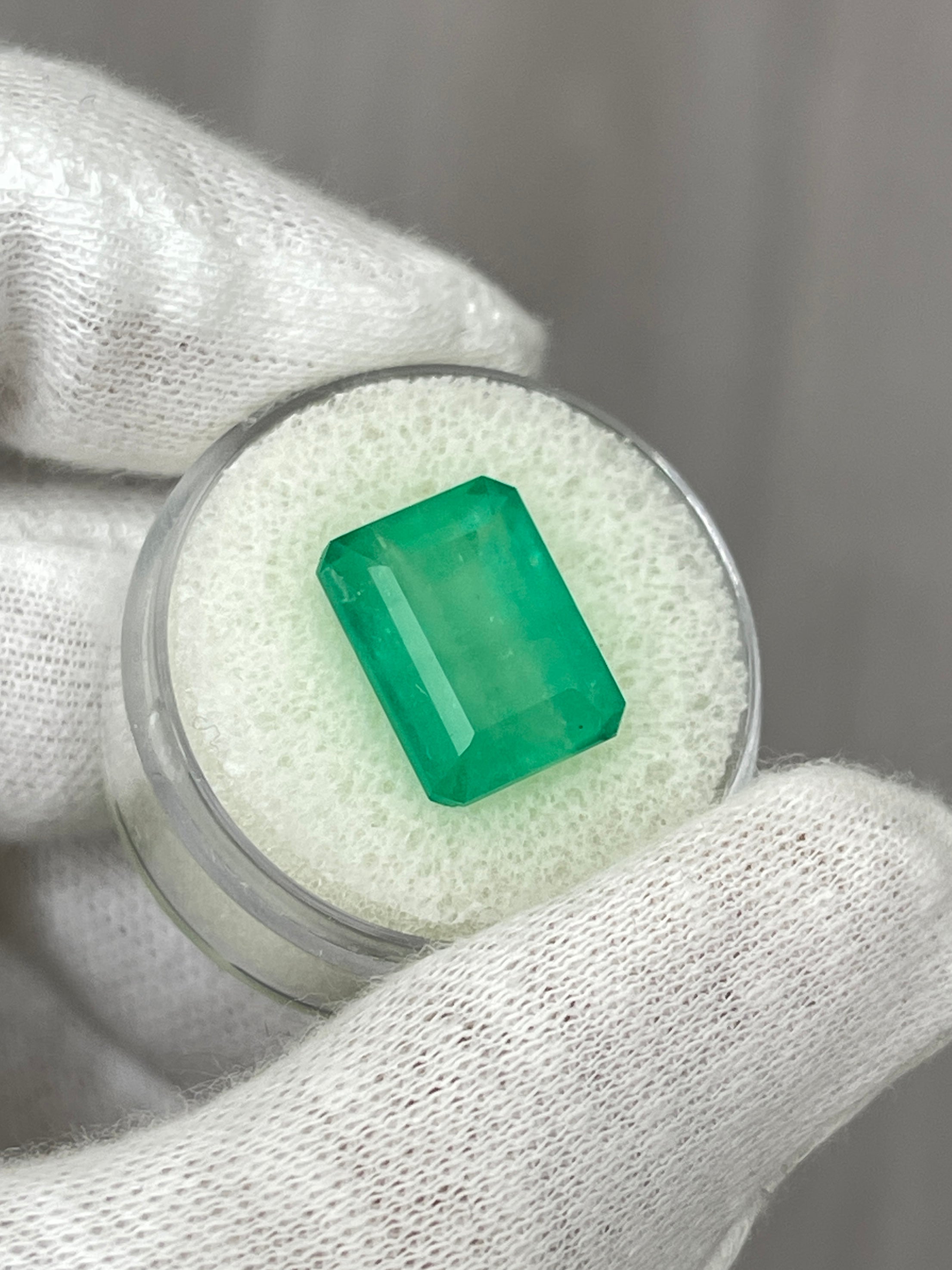 Medium green 9.29 carat Colombian emerald cut loose emerald from JR Colombian Emeralds showing vivid earthy color and faceted gemstone.