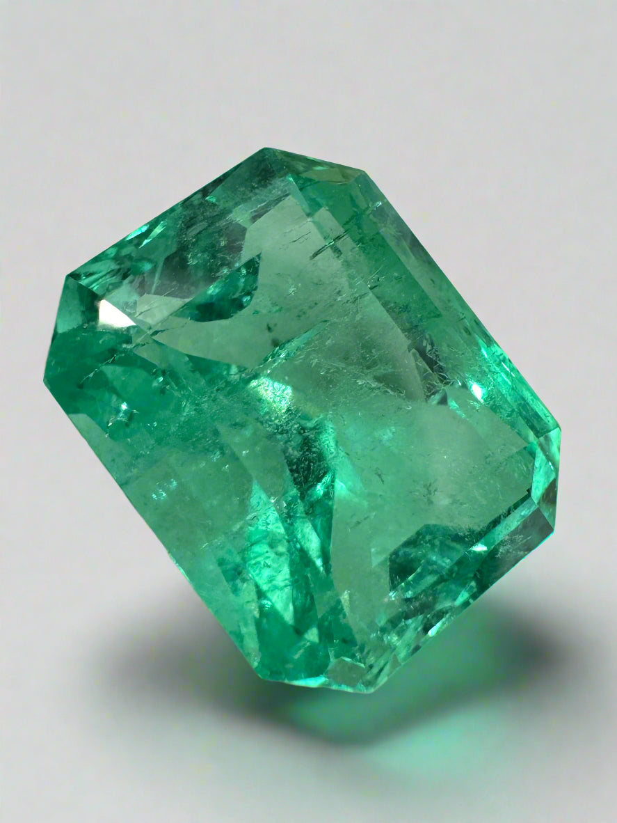9.51 carat vivacious green Colombian emerald cut loose gemstone from JR Colombian Emeralds, showcasing deep green color and clarity.