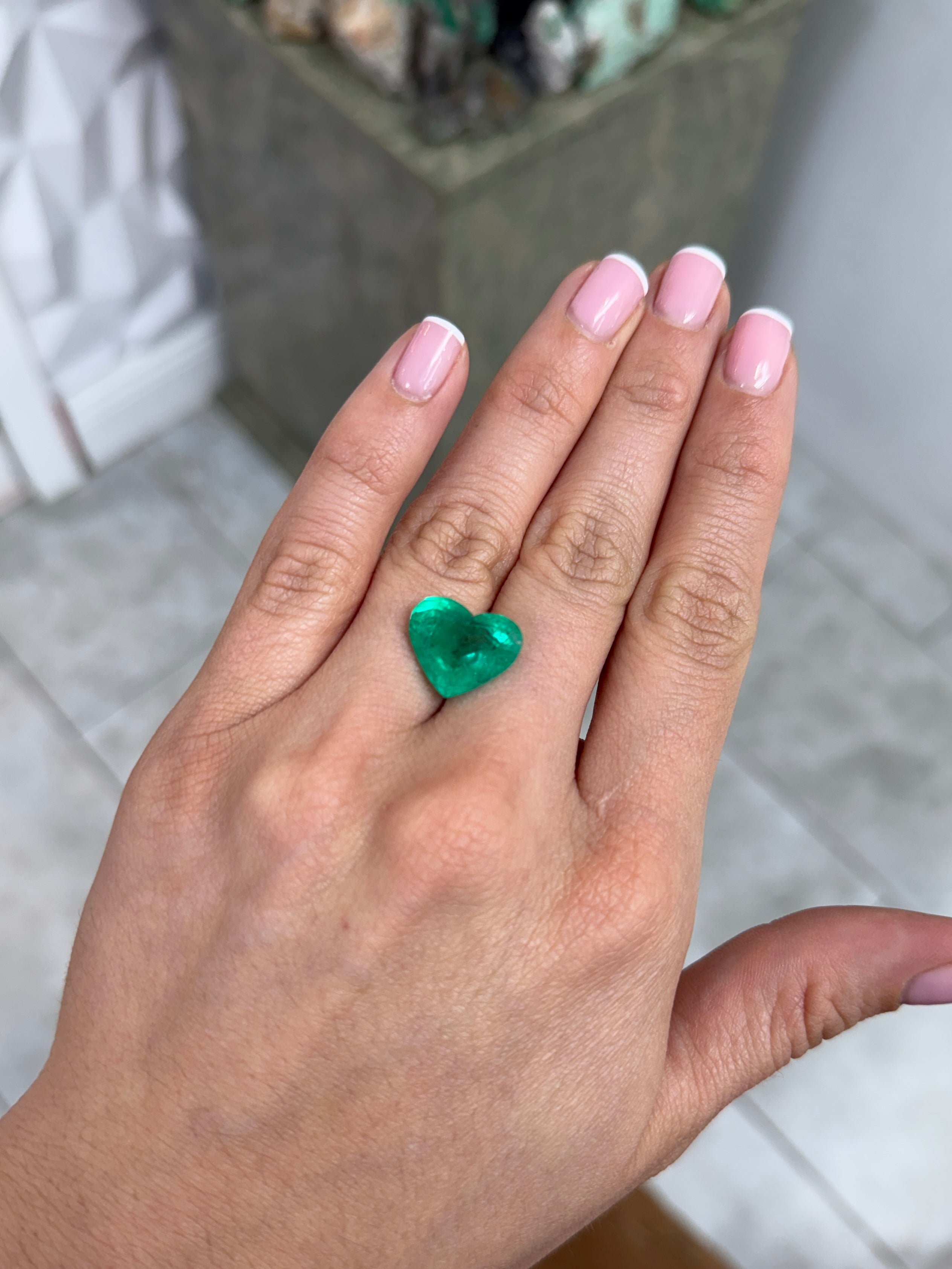 Bright green 9.72 carat natural Colombian emerald in heart cut, showcasing vibrant color and clarity, from JR Colombian Emeralds.