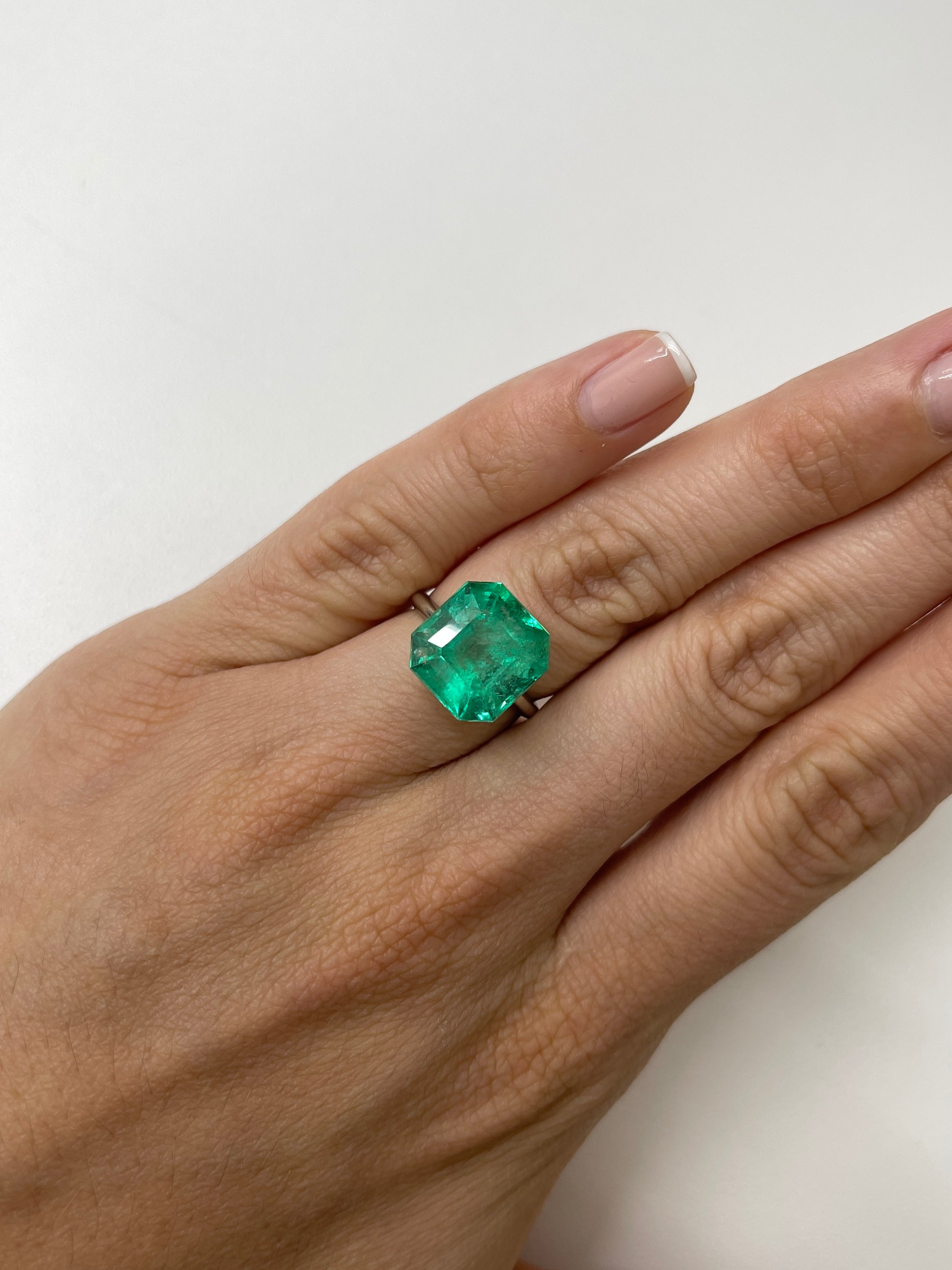 Medium green 9.79 carat natural Colombian emerald in classic Asscher cut, loose gemstone showcasing vibrant color and clarity.