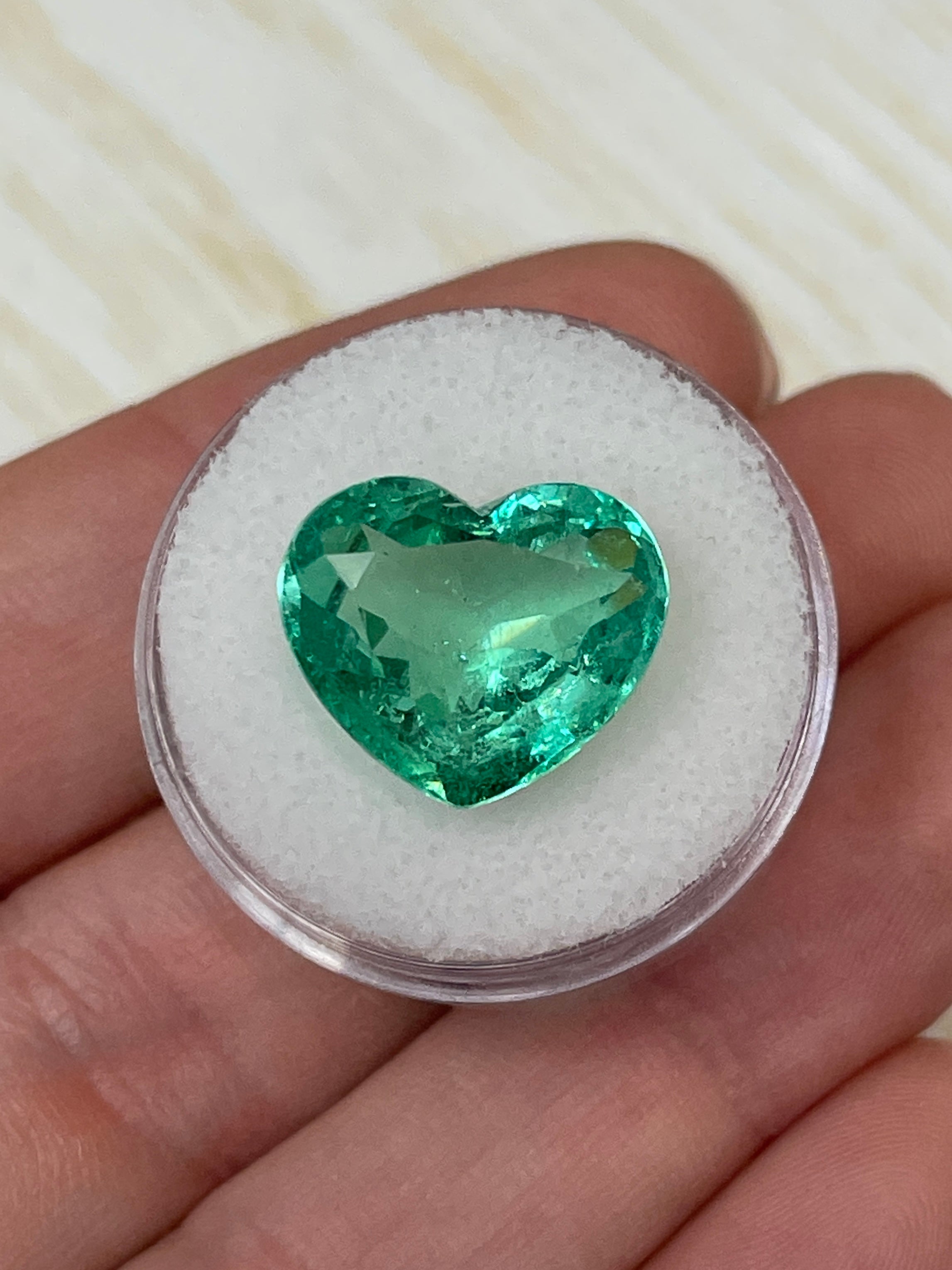 9.84 carat Colombian emerald loose gemstone, heart cut with bubbly eye-clean clarity, natural and vibrant green color.
