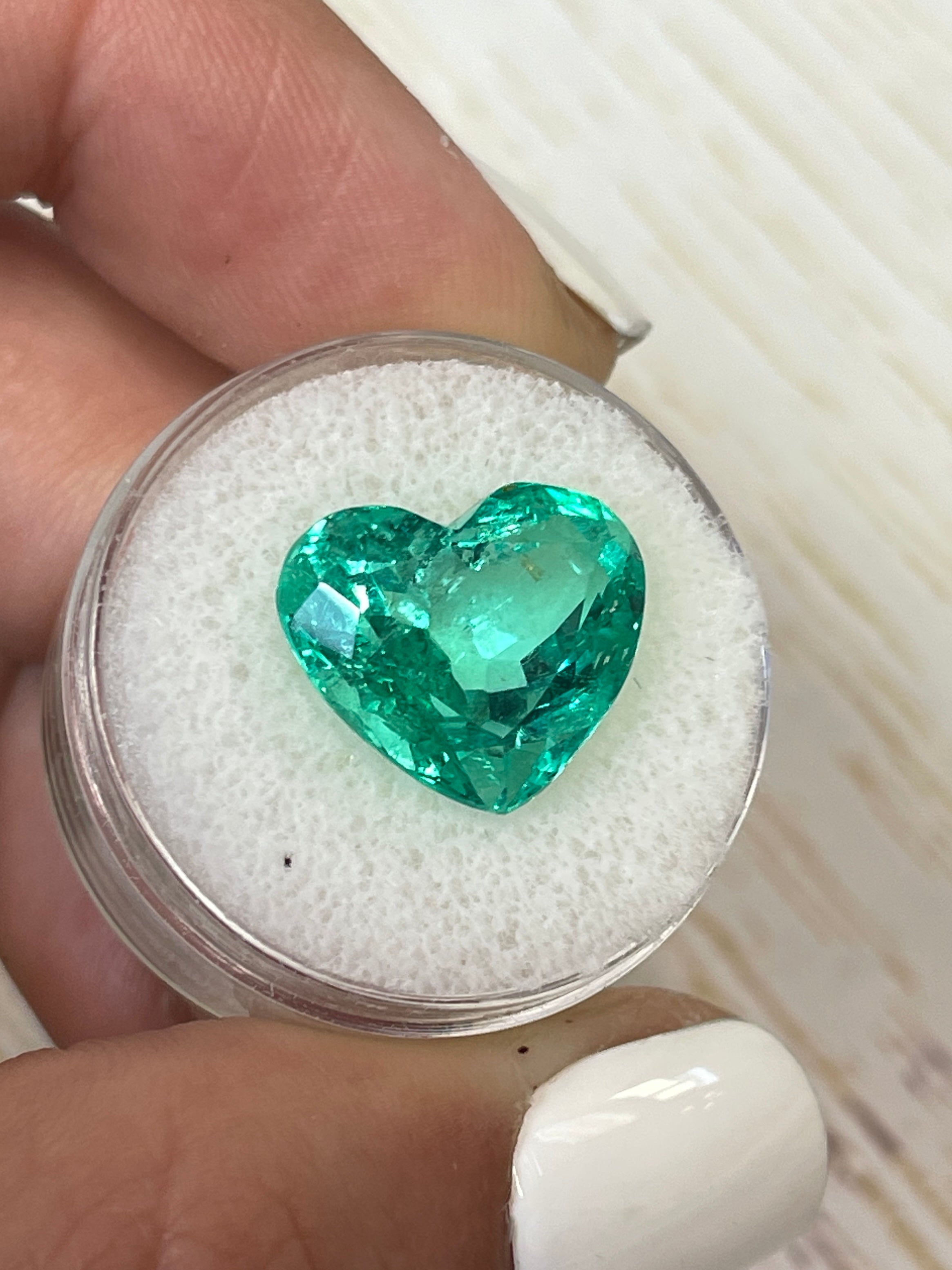 9.86 carat yellowish green natural Colombian emerald in heart cut, loose gemstone from JR Colombian Emeralds.