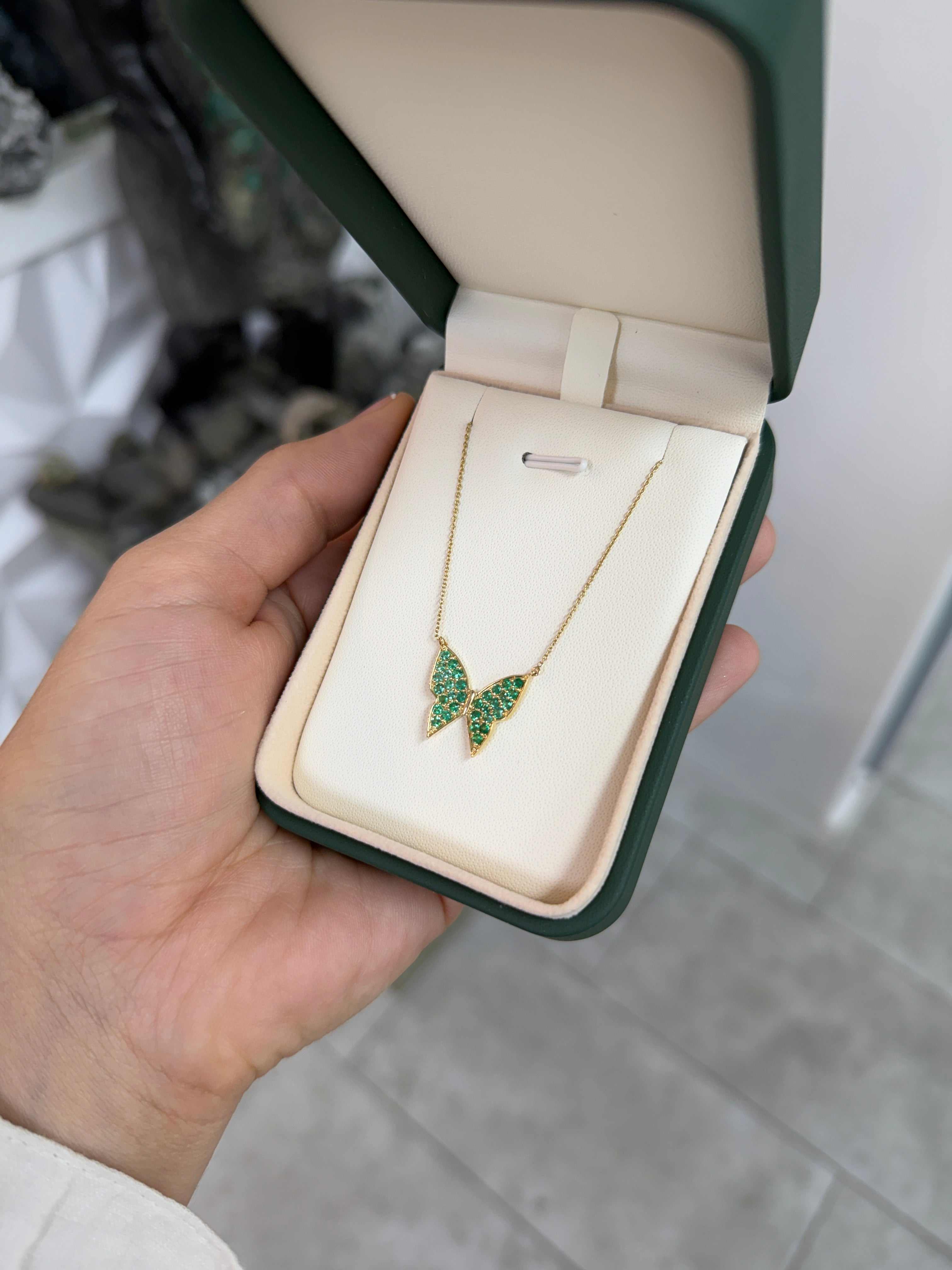 14K gold butterfly pendant necklace with pave emeralds, featuring a fluttering butterfly design from JR Colombian Emeralds.