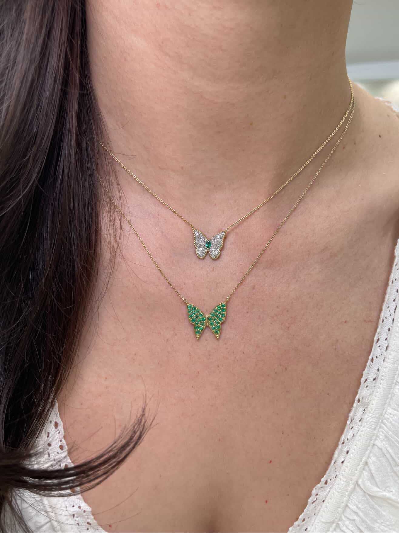 14K gold butterfly necklace with emerald pave accents, featuring a delicate fluttering butterfly design by JR Colombian Emeralds