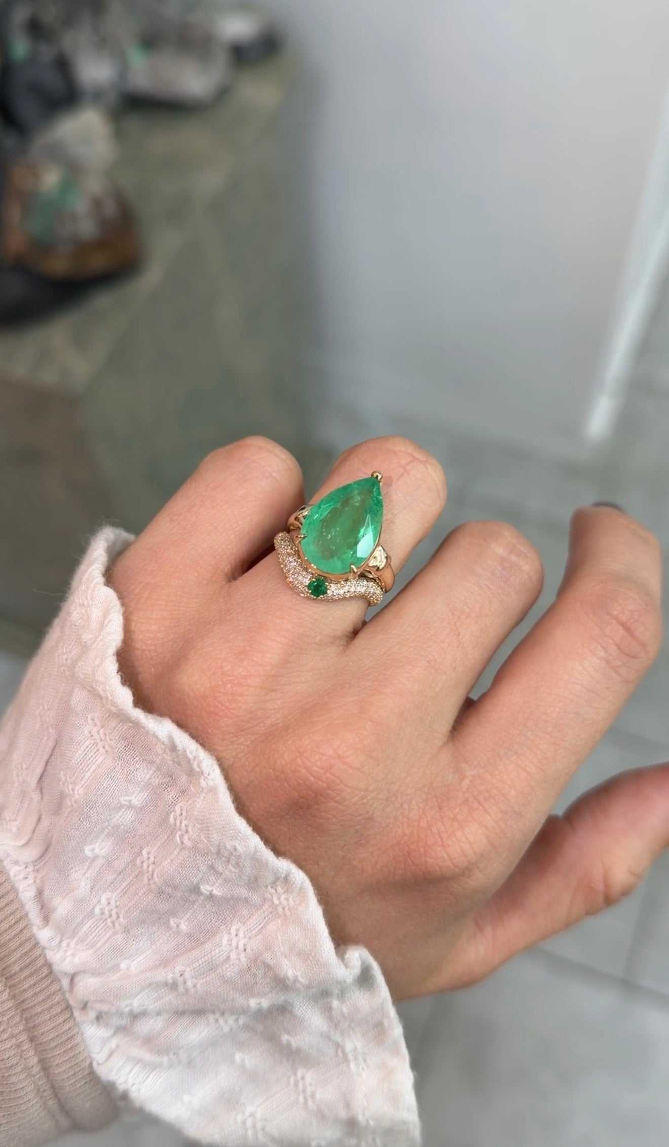 Custom curved emerald and diamond pave wedding band in 14K gold, size 7, by JR Colombian Emeralds, showcasing detailed craftsmanship.