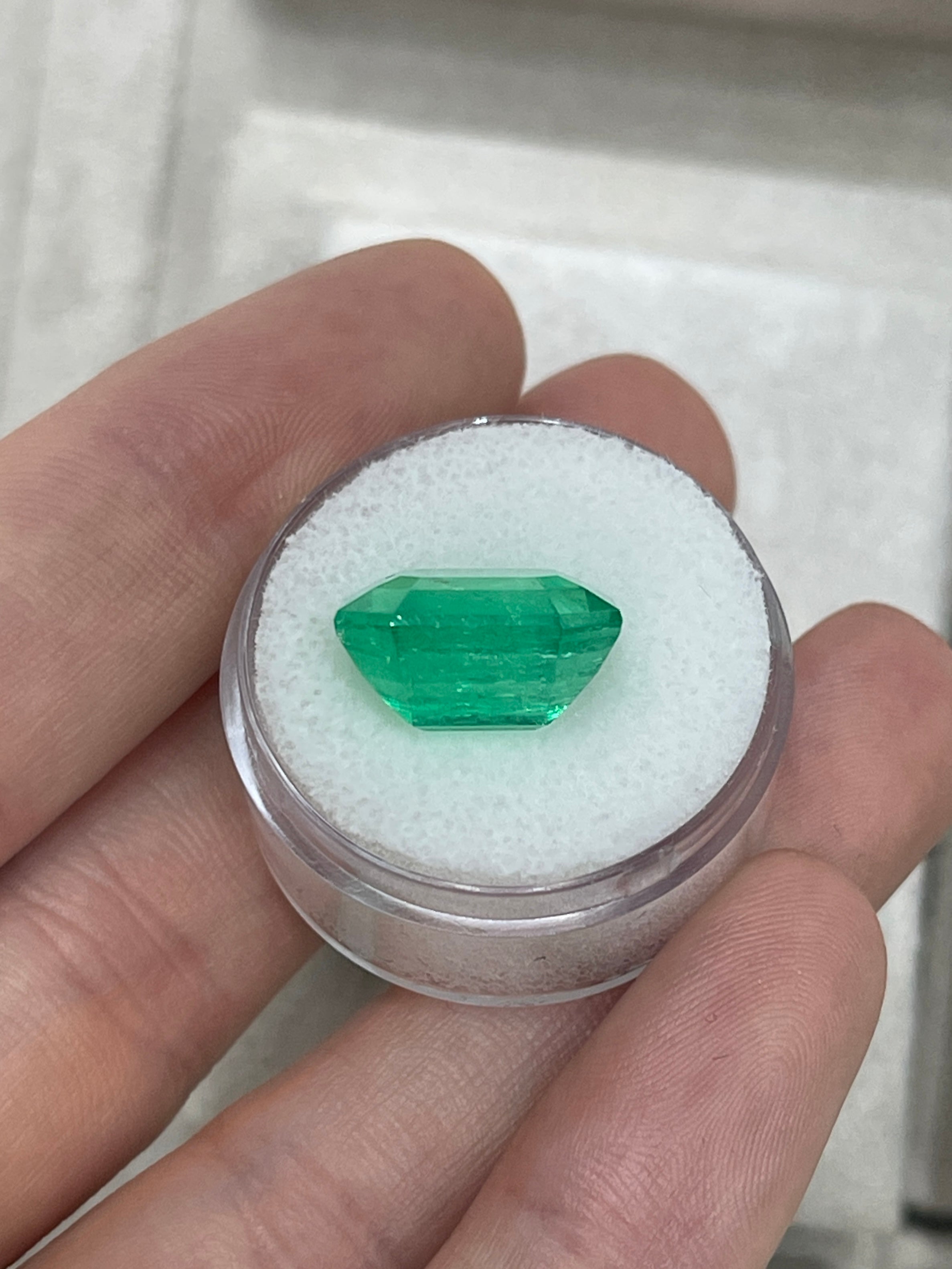 Large 10.97 carat Muzo Colombian emerald loose gemstone in emerald cut, deep jungle green, from JR Colombian Emeralds.