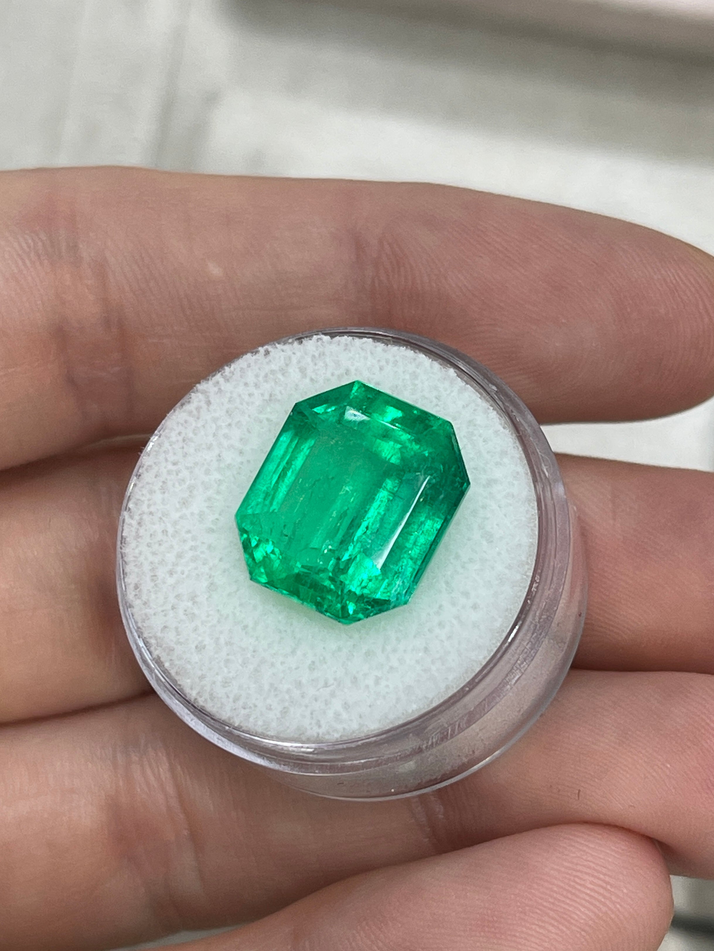 Large 10.97 carat Muzo Colombian emerald loose gemstone in emerald cut with deep jungle green color.