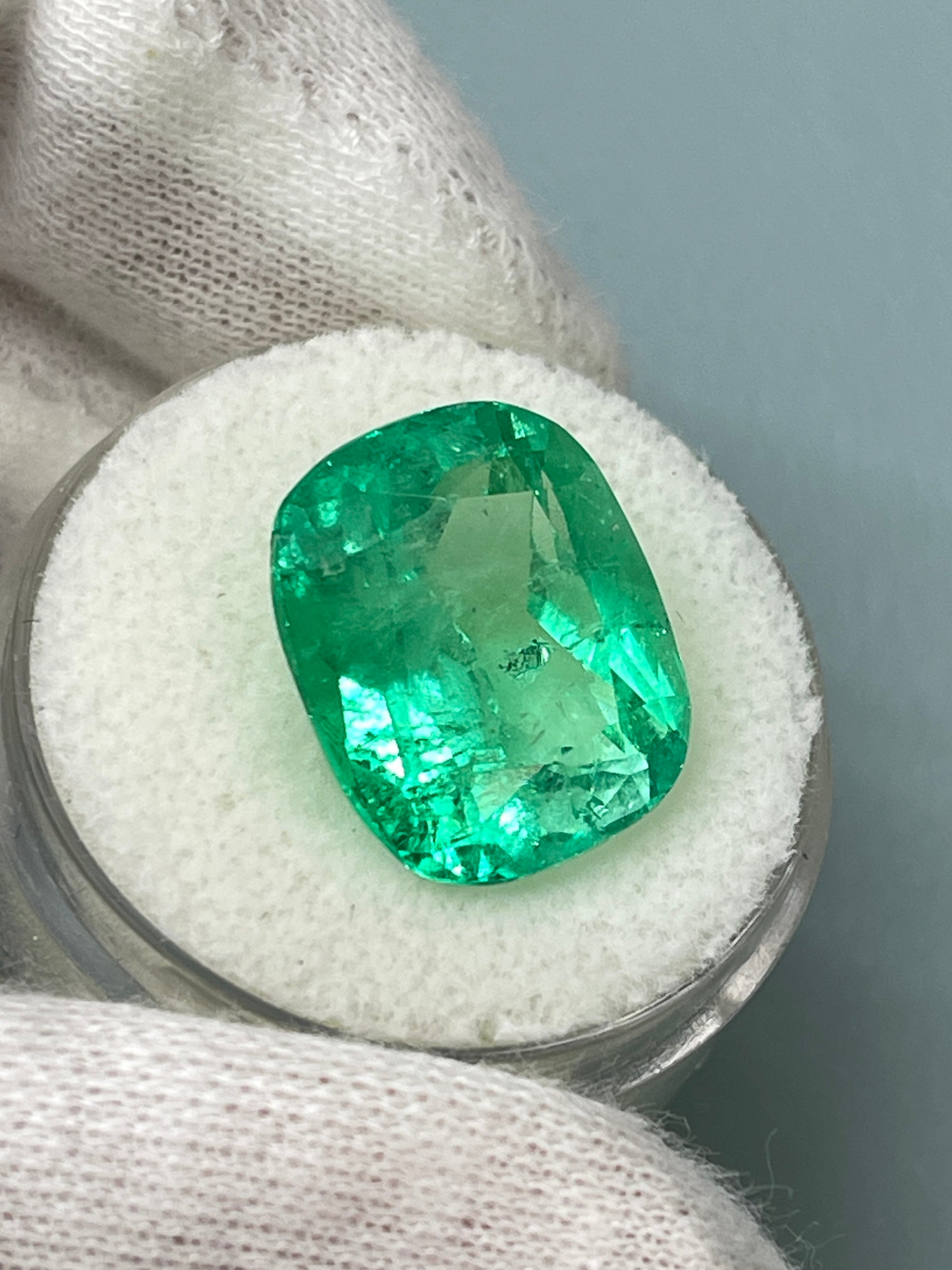 Large 11.50 carat yellowish Muzo Colombian emerald cushion cut gemstone from JR Colombian Emeralds.