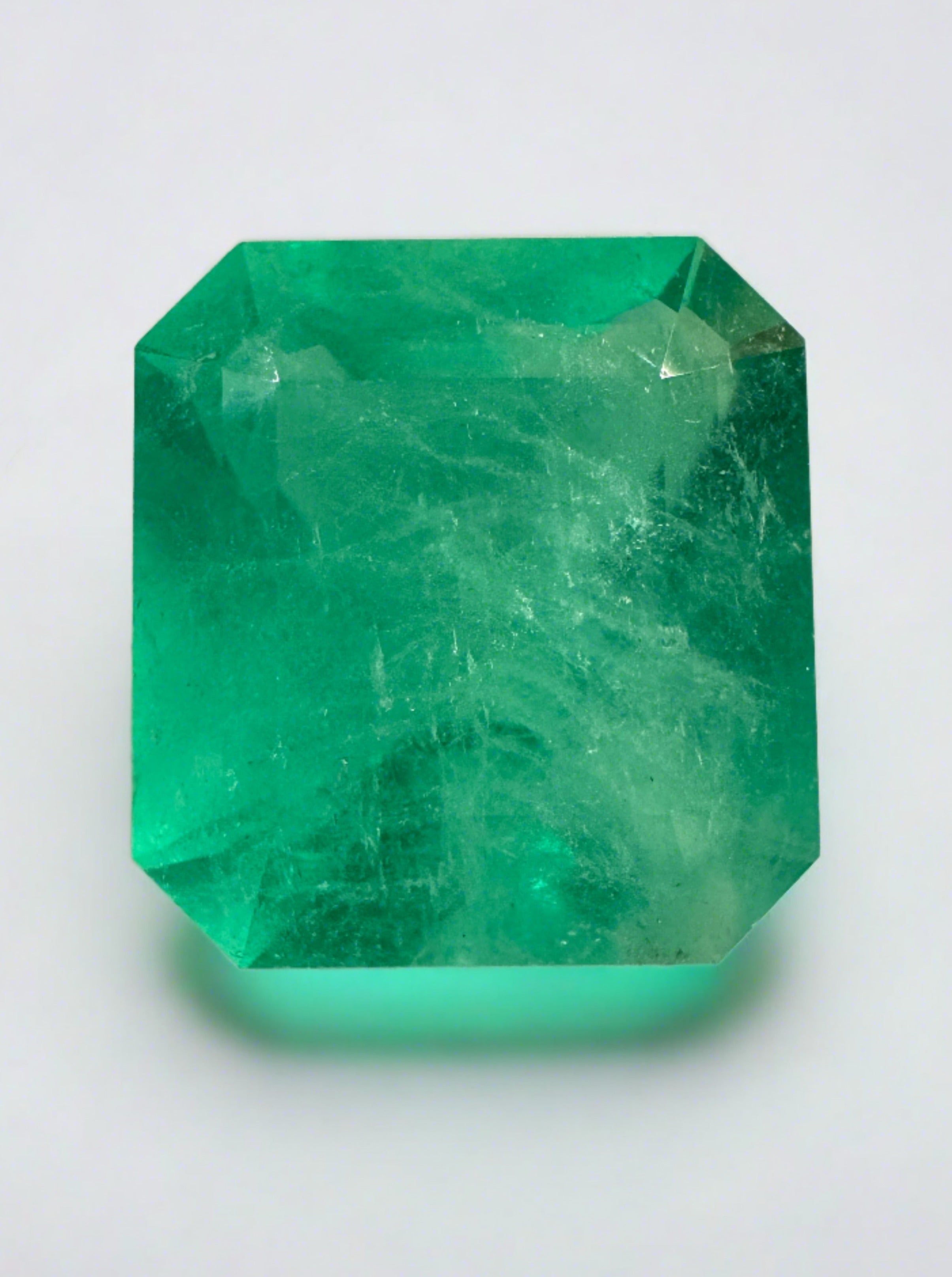 Large 12.09-carat 15x14mm loose Colombian emerald with Asscher cut, showcased by JR Colombian Emeralds.
