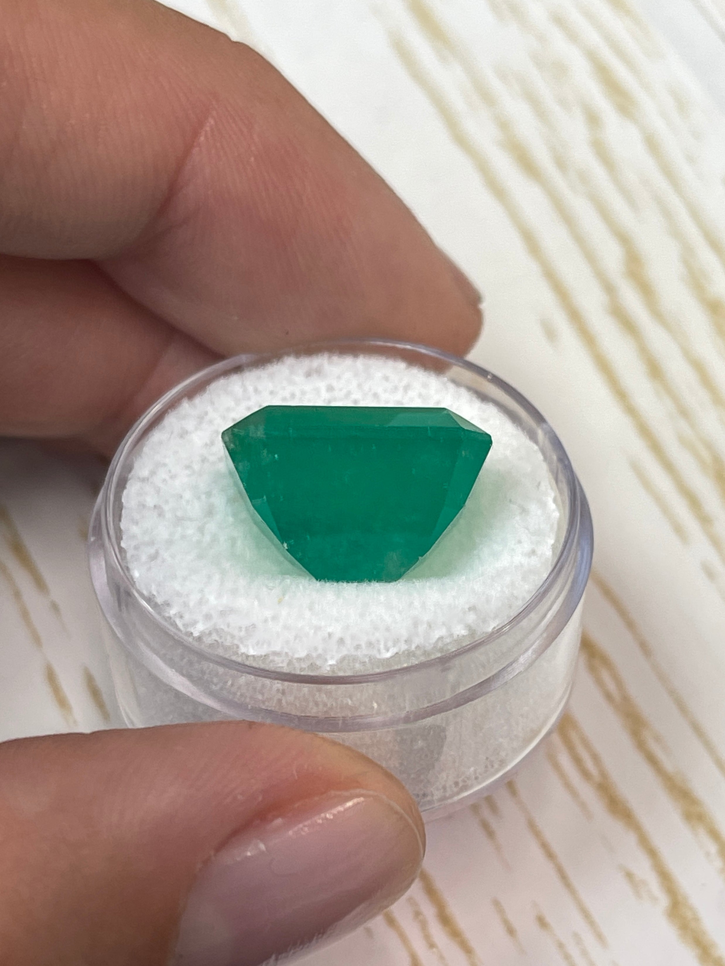 Large 12.13 carat natural Colombian emerald in an emerald cut, showcasing vibrant green color and clarity.