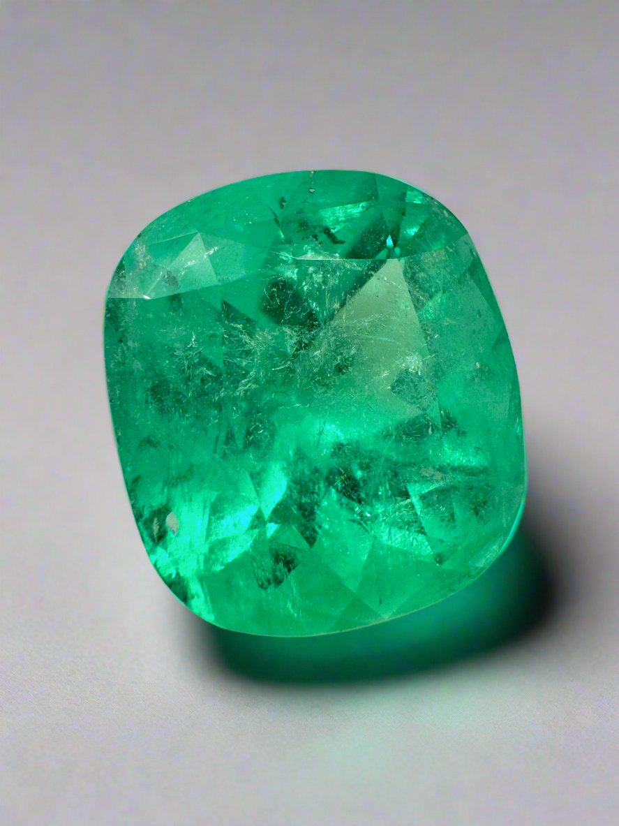 Large 12.27 carat Muzo Colombian emerald, cushion cut, yellowish green, natural loose gemstone from JR Colombian Emeralds.