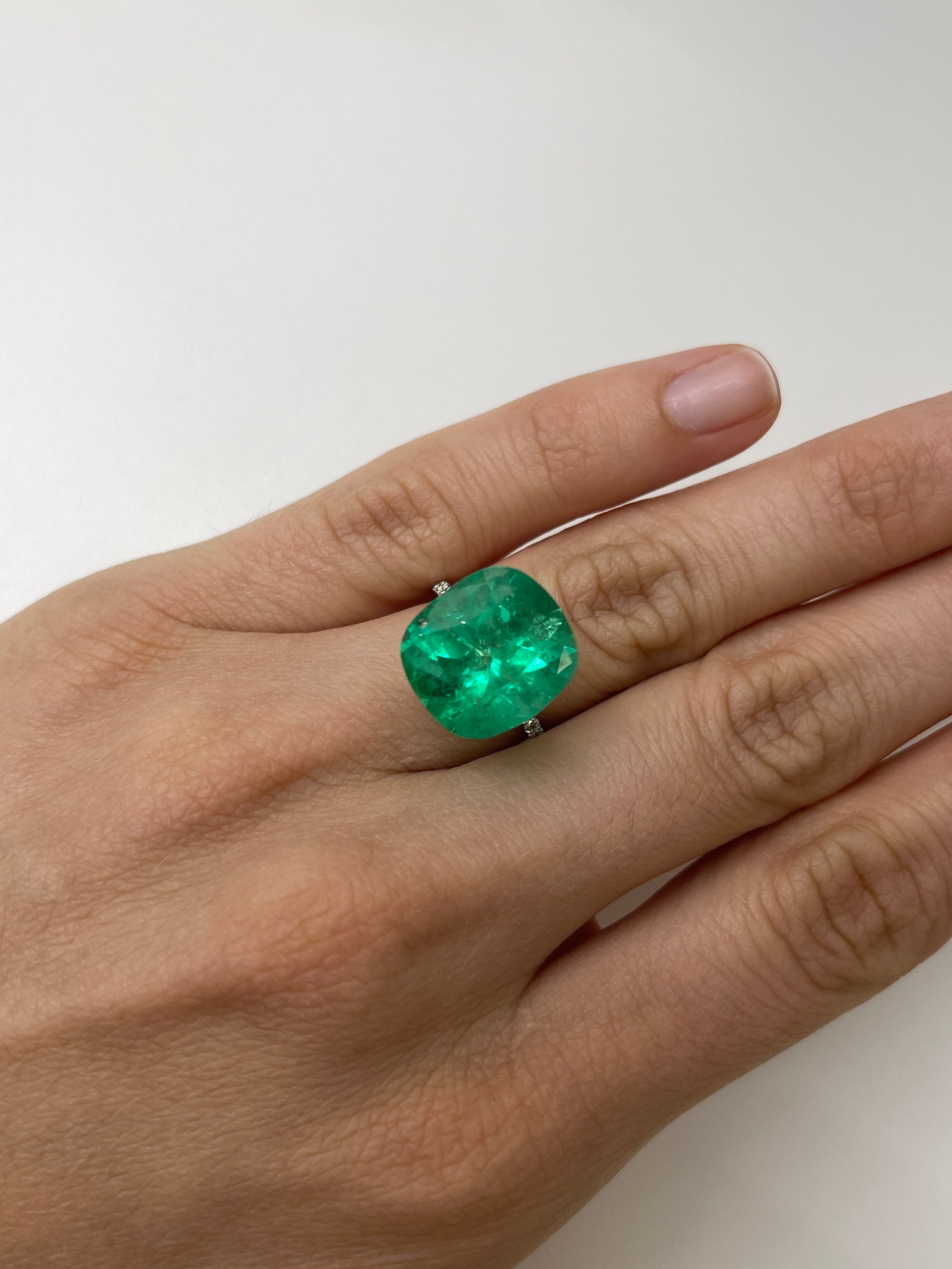 Large 12.27 carat Muzo yellowish green Colombian emerald loose cushion cut gemstone from JR Colombian Emeralds.