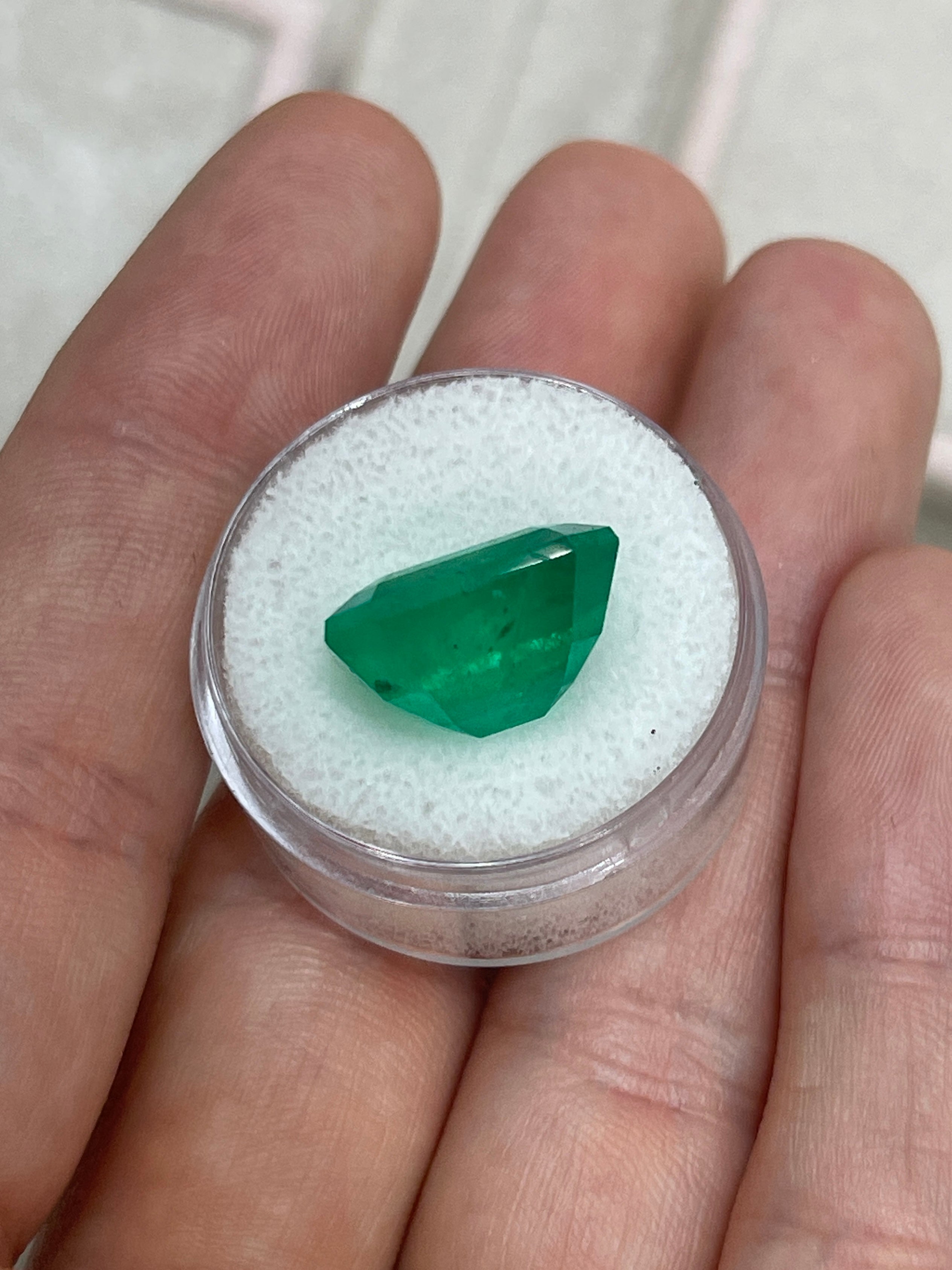Large 13.04 carat AAA+ Colombian emerald cut loose gemstone from JR Colombian Emeralds, showcasing vibrant green color and clarity.