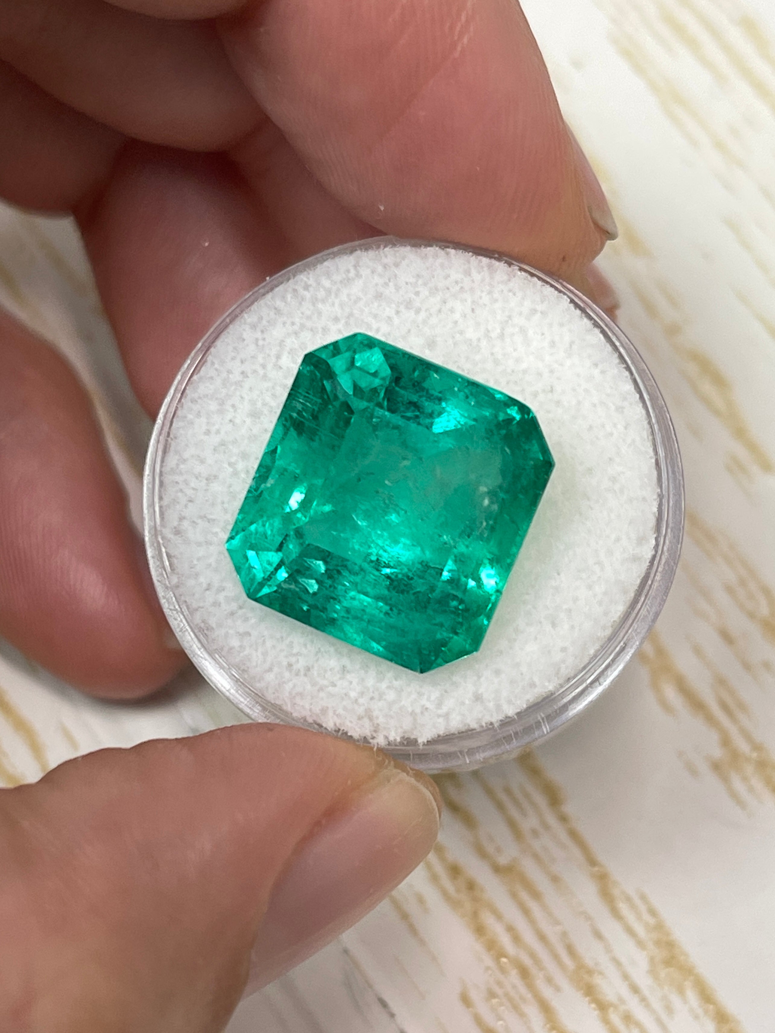Large 15.28 carat GIA-certified Colombian emerald in an emerald cut, loose gemstone with vibrant green color.