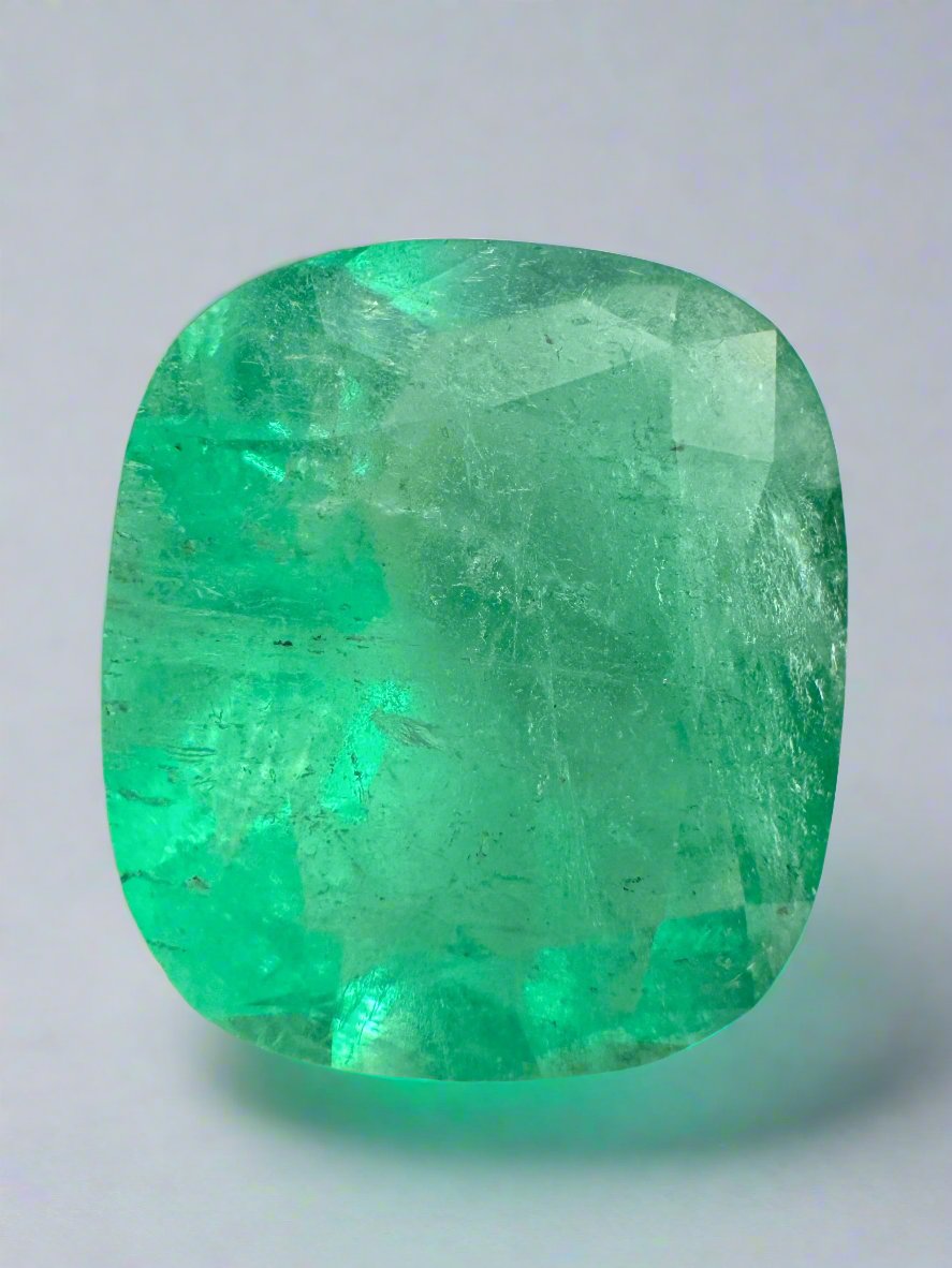 Large 17.5x15 Colombian Emerald cushion cut gemstone from JR Colombian Emeralds, showcasing vibrant green color and natural clarity.