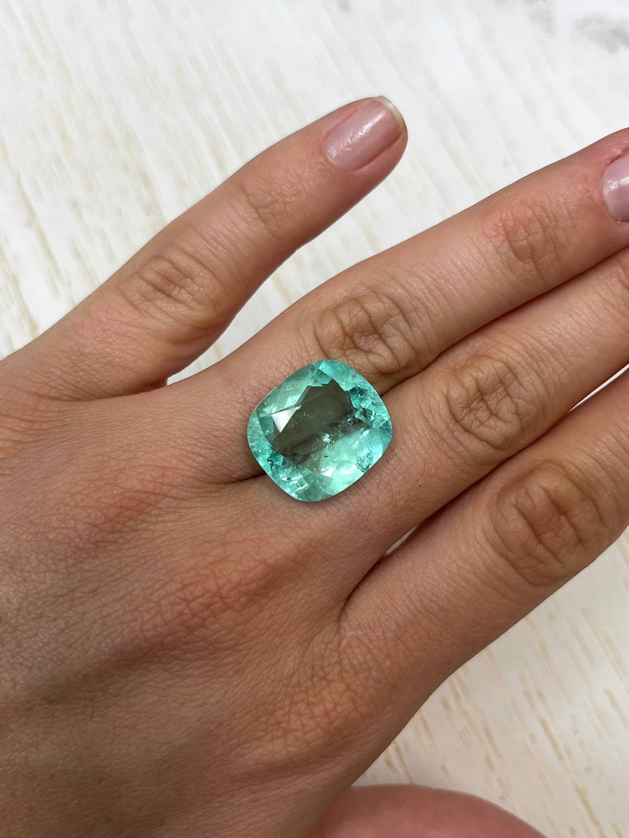 Large 19.41 carat VS pastel green Colombian emerald loose cushion cut from JR Colombian Emeralds.