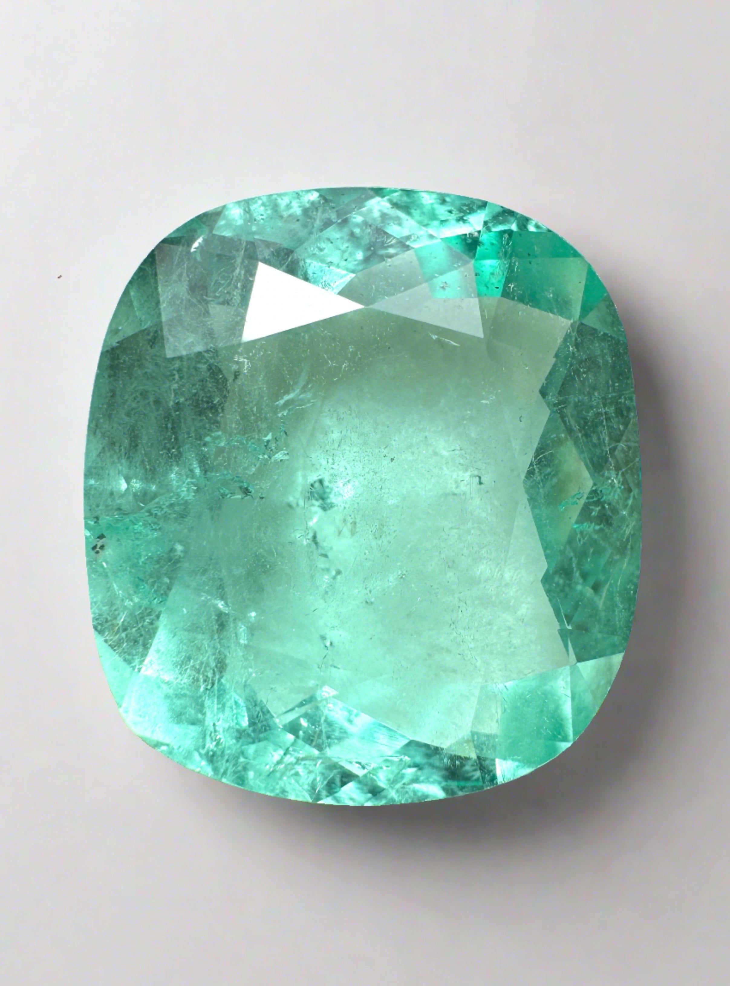 Large 19.41-carat natural Colombian emerald, cushion cut, pastel green, VS clarity, loose gemstone from JR Colombian Emeralds.