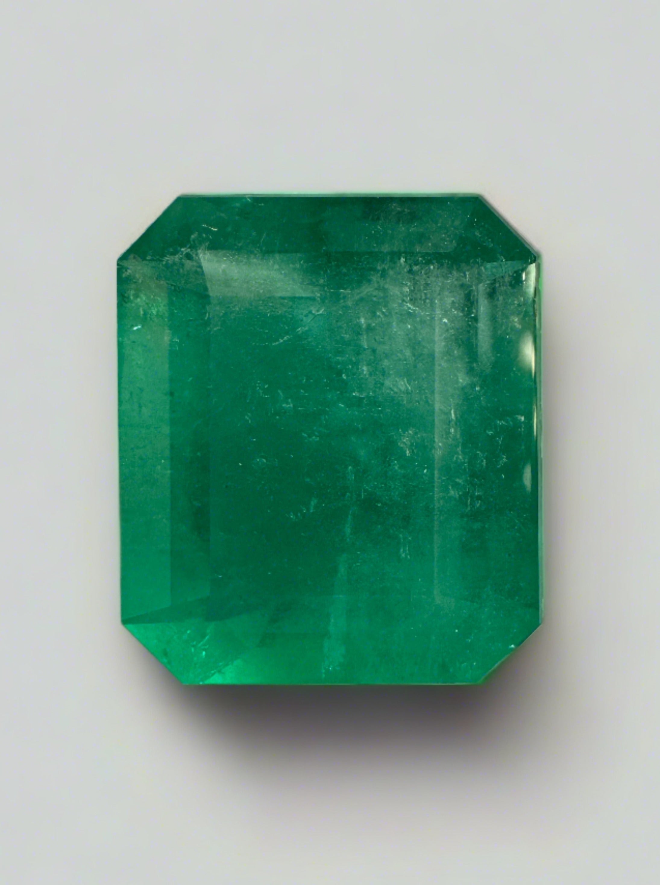 Large 22.54 carat natural Colombian emerald in an emerald cut, showcasing vibrant green color and clarity.