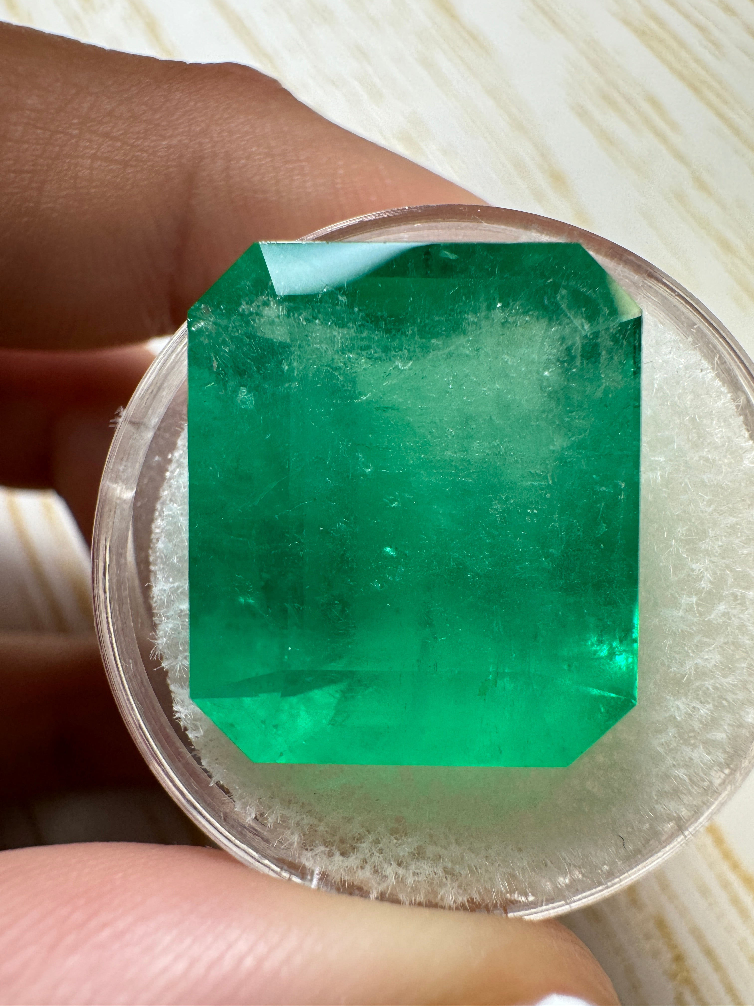 Large 22.54 carat natural Colombian emerald in an emerald cut, showcasing vibrant green color and clarity.