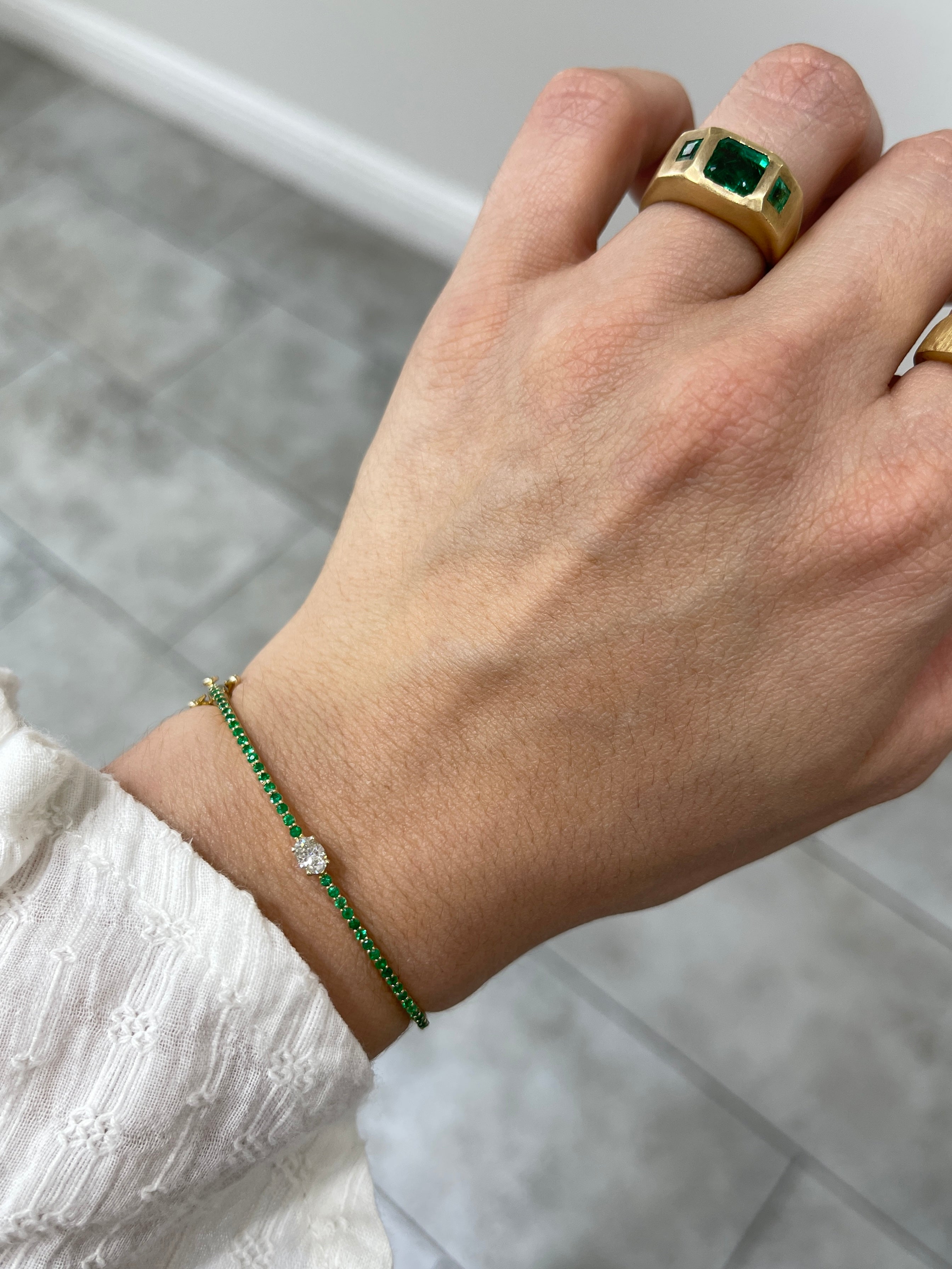Oval diamond and emerald bangle bracelet in 14K yellow gold for a 5.5-inch wrist, featuring JR Colombian Emeralds.