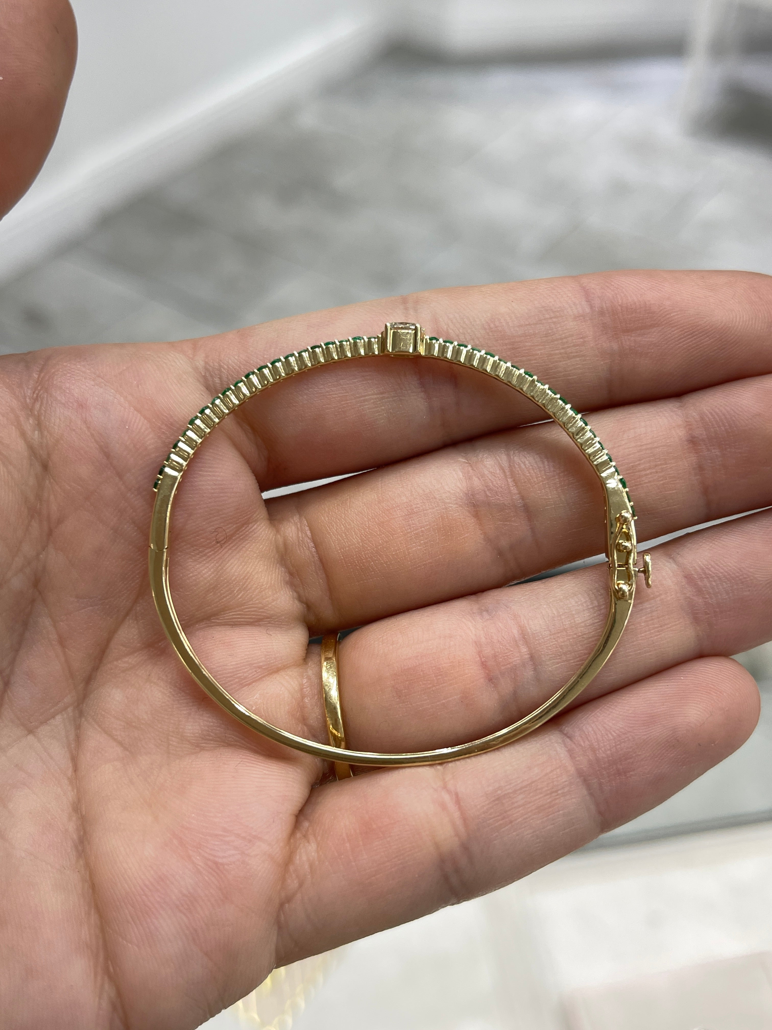 Oval diamond and emerald bangle bracelet in 14K yellow gold, designed for a 5.5-inch wrist, by JR Colombian Emeralds.