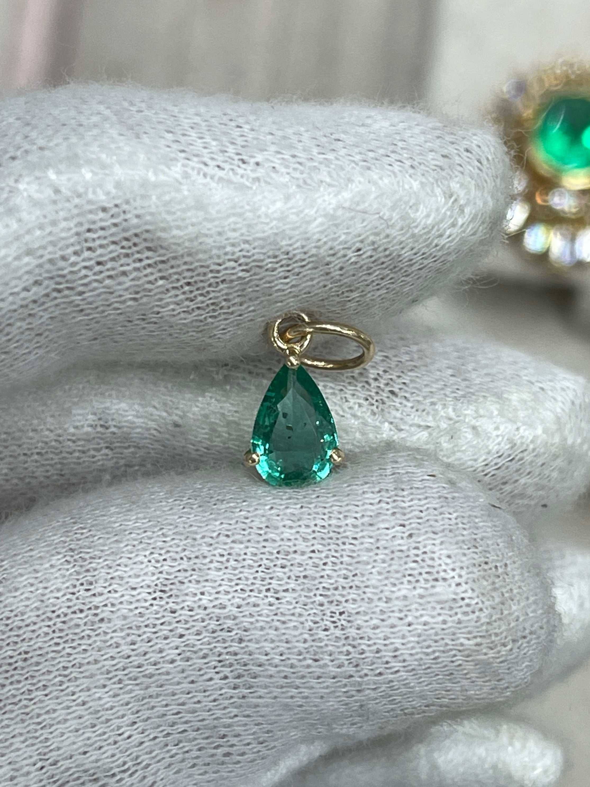 Petite 0.70ct natural freckled teardrop emerald prong pendant in 14K gold by JR Colombian Emeralds, showcasing a vibrant green gemstone.