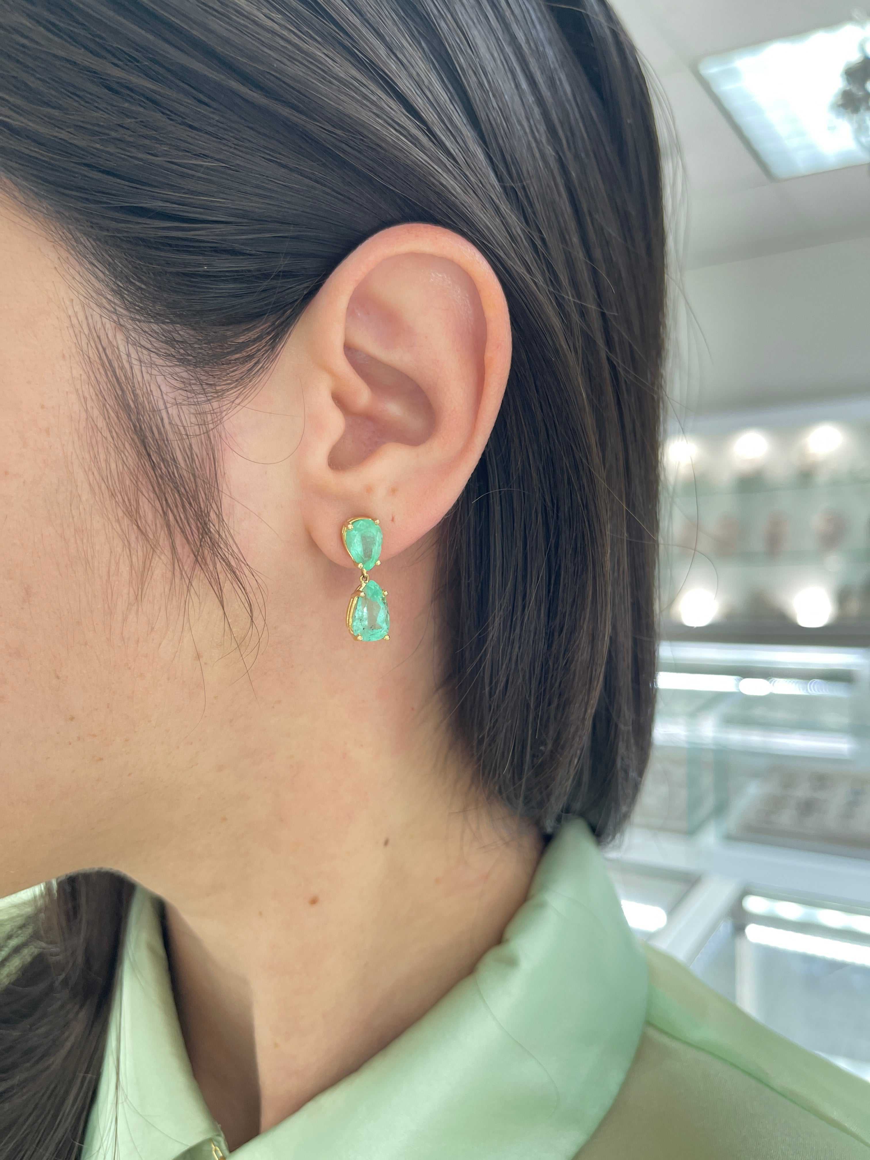 Teardrop natural Colombian emerald dangle earrings in 14K gold from JR Colombian Emeralds, showcasing vibrant green gemstones.
