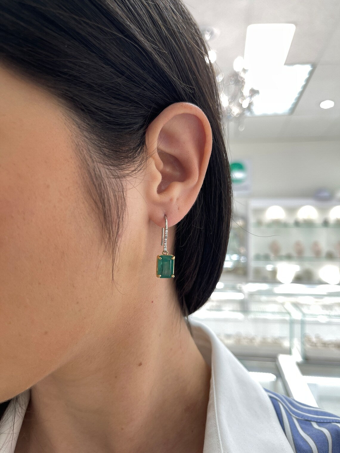 JR Colombian Emeralds earrings featuring 8.32 tcw emerald dangles with diamond accents and leverback hooks.