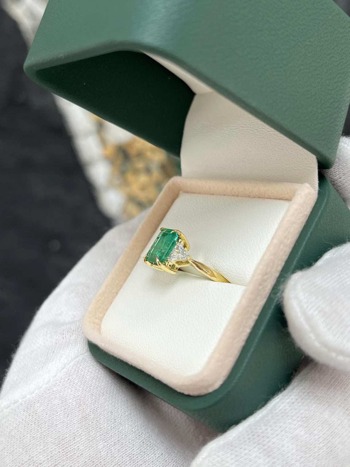 2.37 Carat Emerald Cut Emerald Features Trillion Diamond Side Stones
