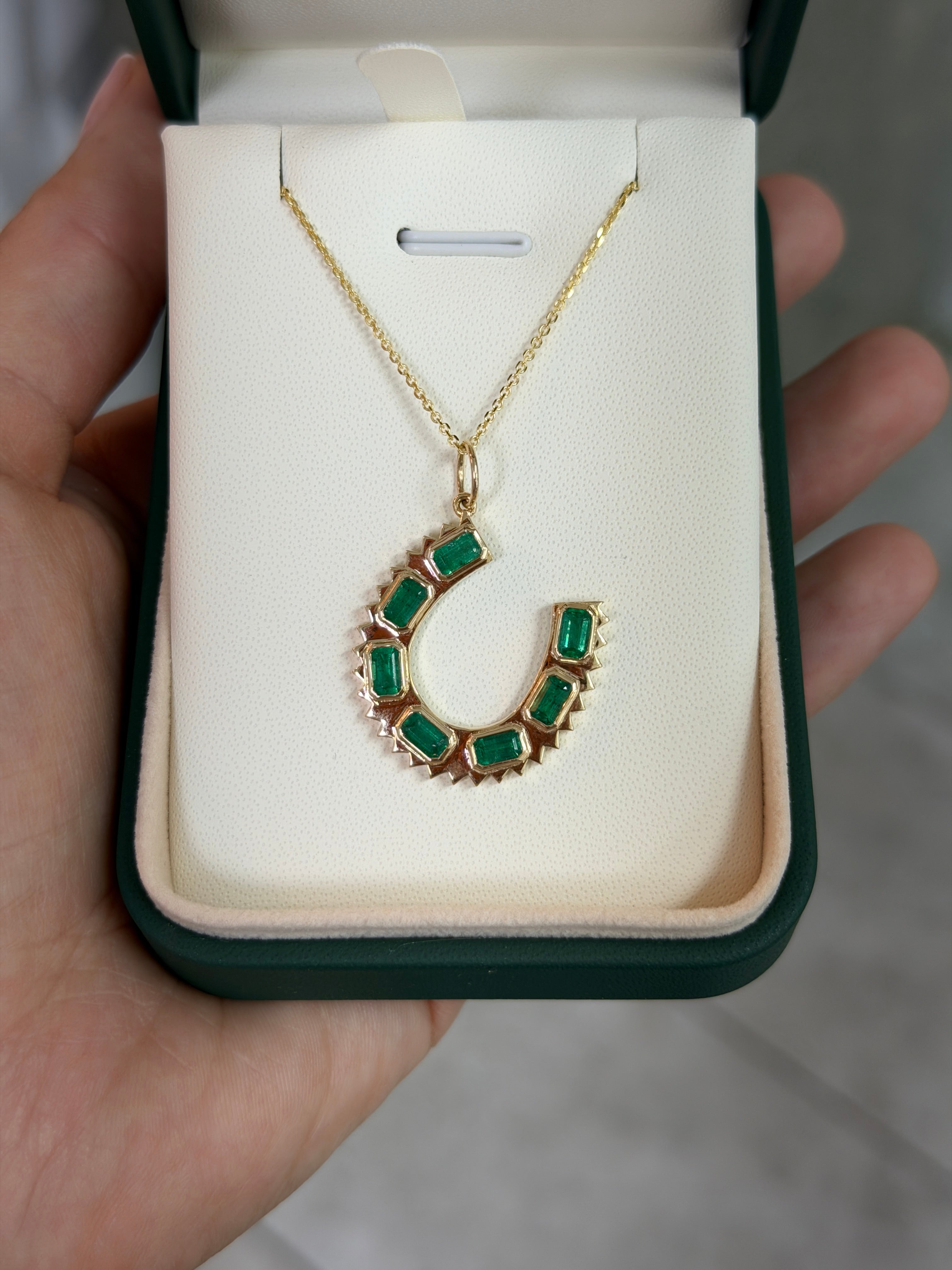 14K natural emerald cut horseshoe charm pendant necklace with 2.24tcw emeralds, designed by JR Colombian Emeralds.