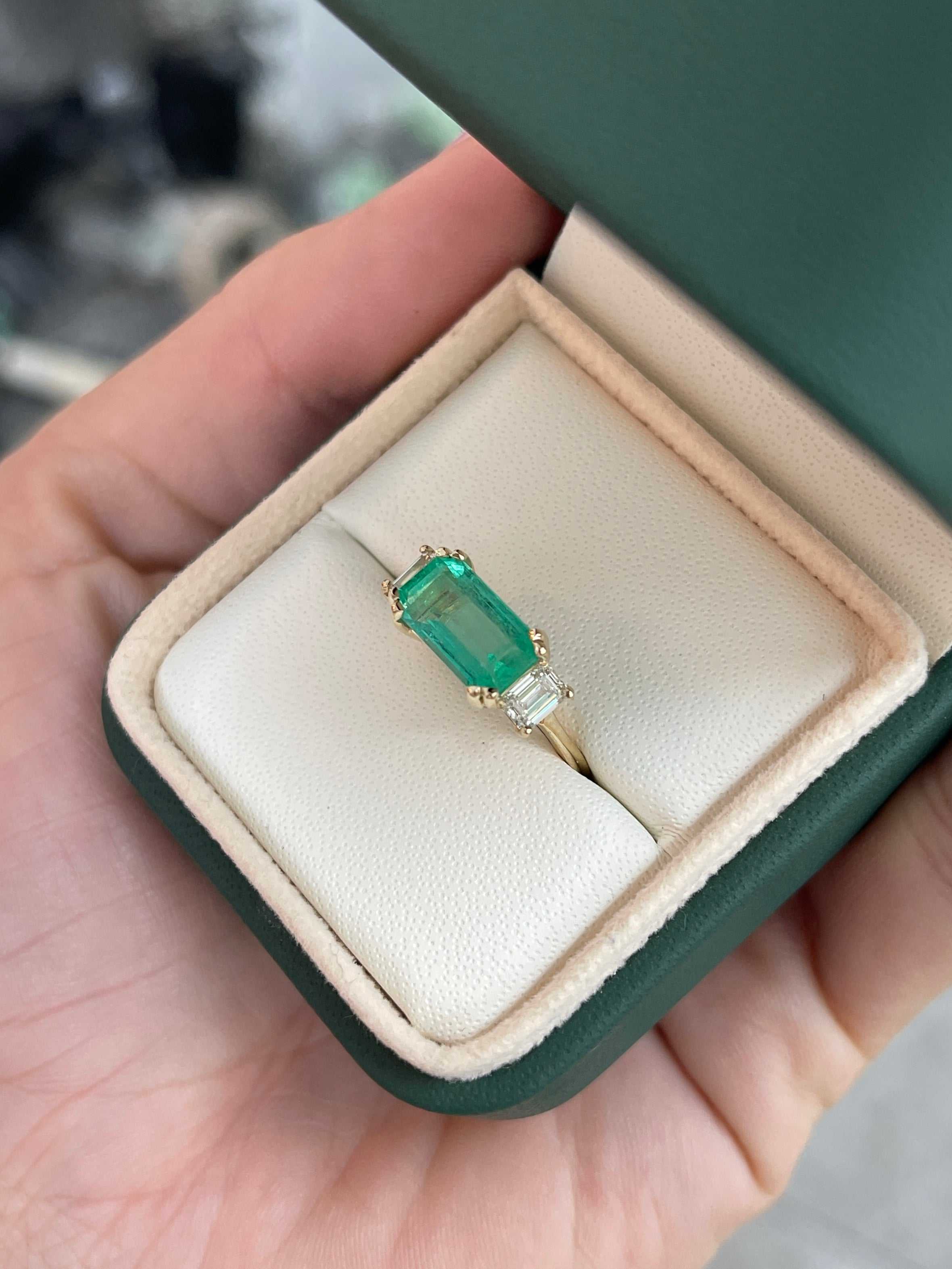 Three-stone emerald and emerald cut diamond engagement ring in 14K gold by JR Colombian Emeralds, showcasing vibrant green stones.