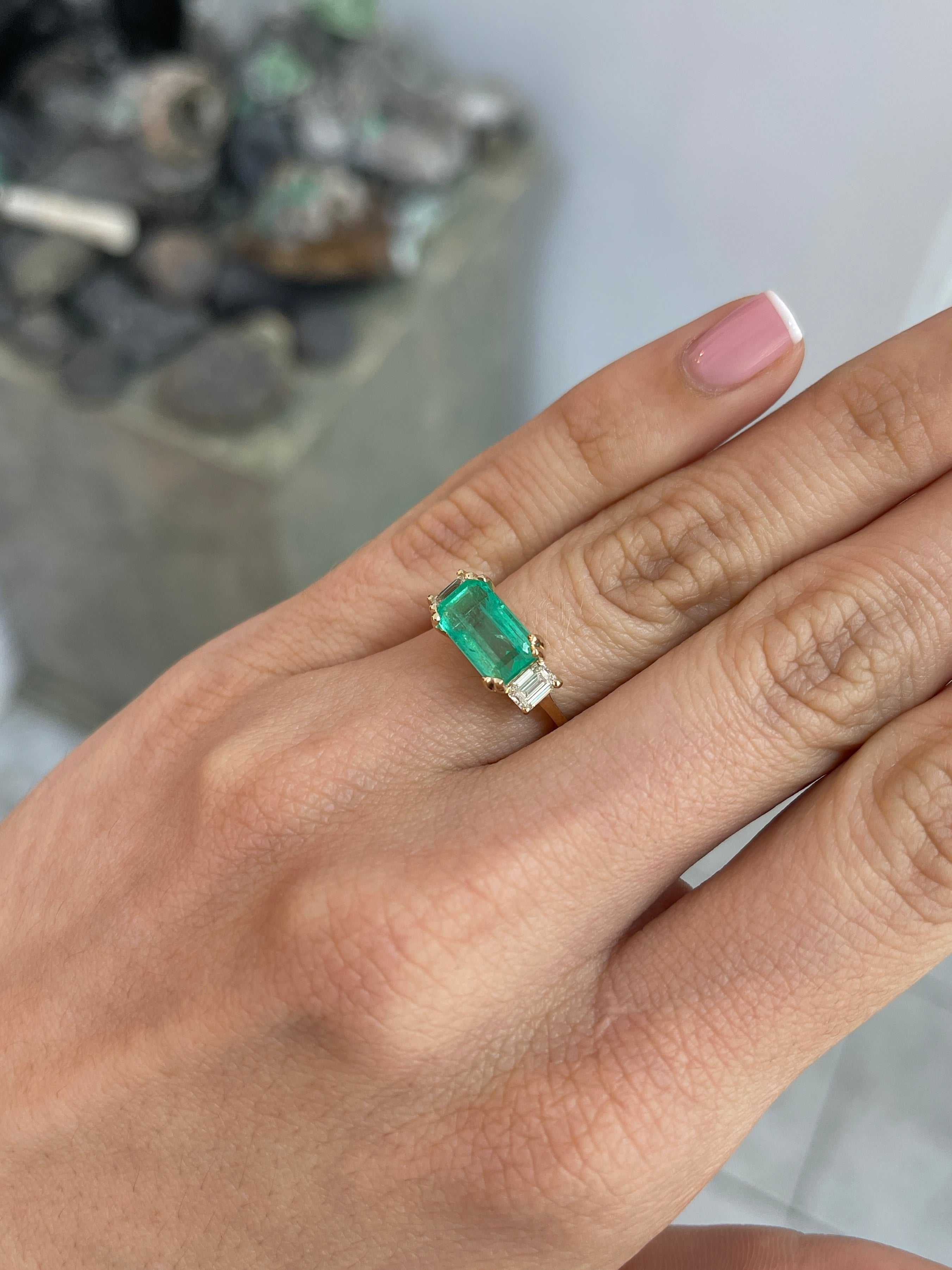 Three stone emerald and emerald cut diamond engagement ring in 14K gold by JR Colombian Emeralds, showcasing vibrant gemstones.