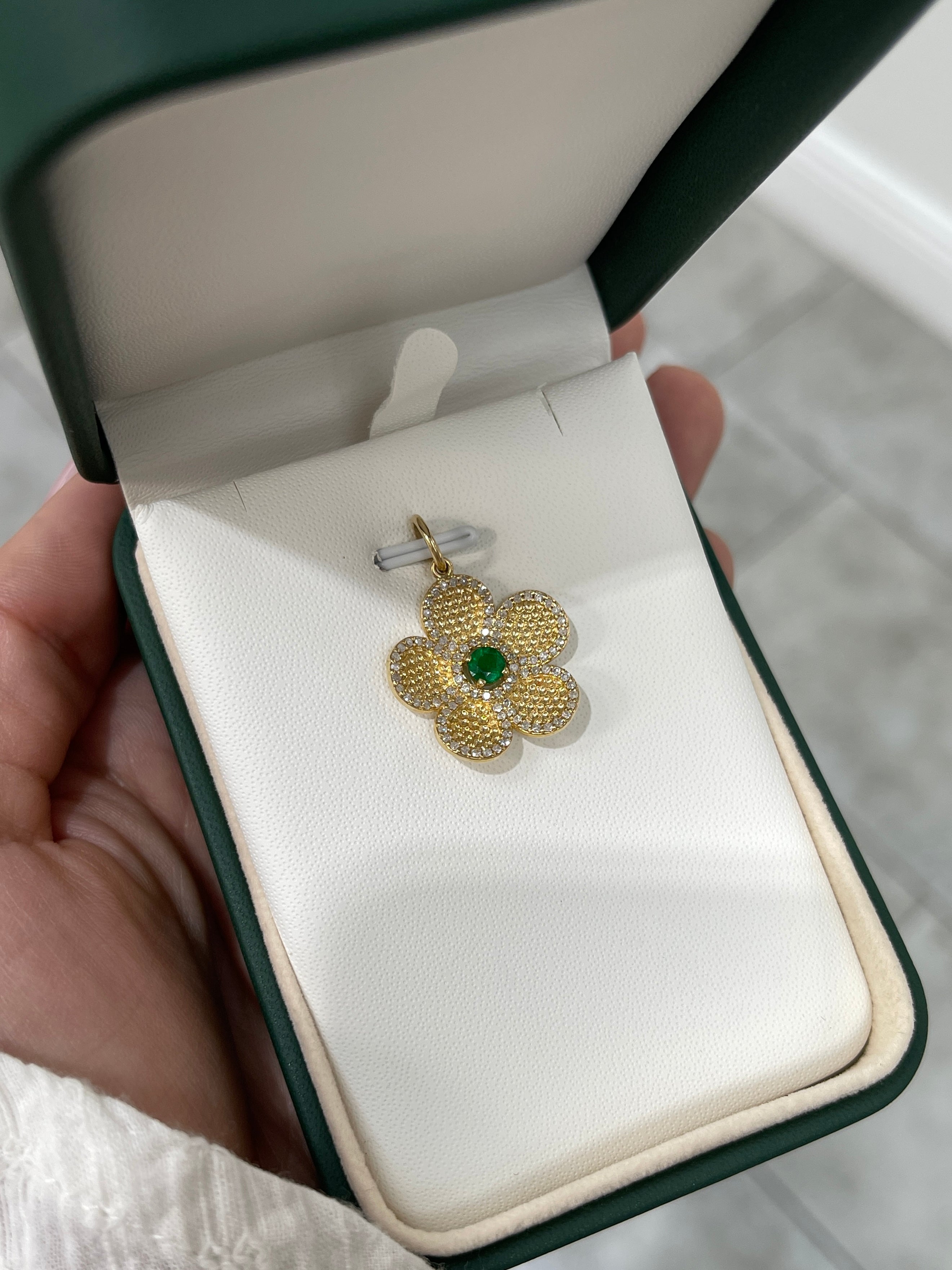 14K gold emerald and diamond flower pendant with 0.58tcw, featuring vibrant Colombian emeralds and sparkling diamonds.