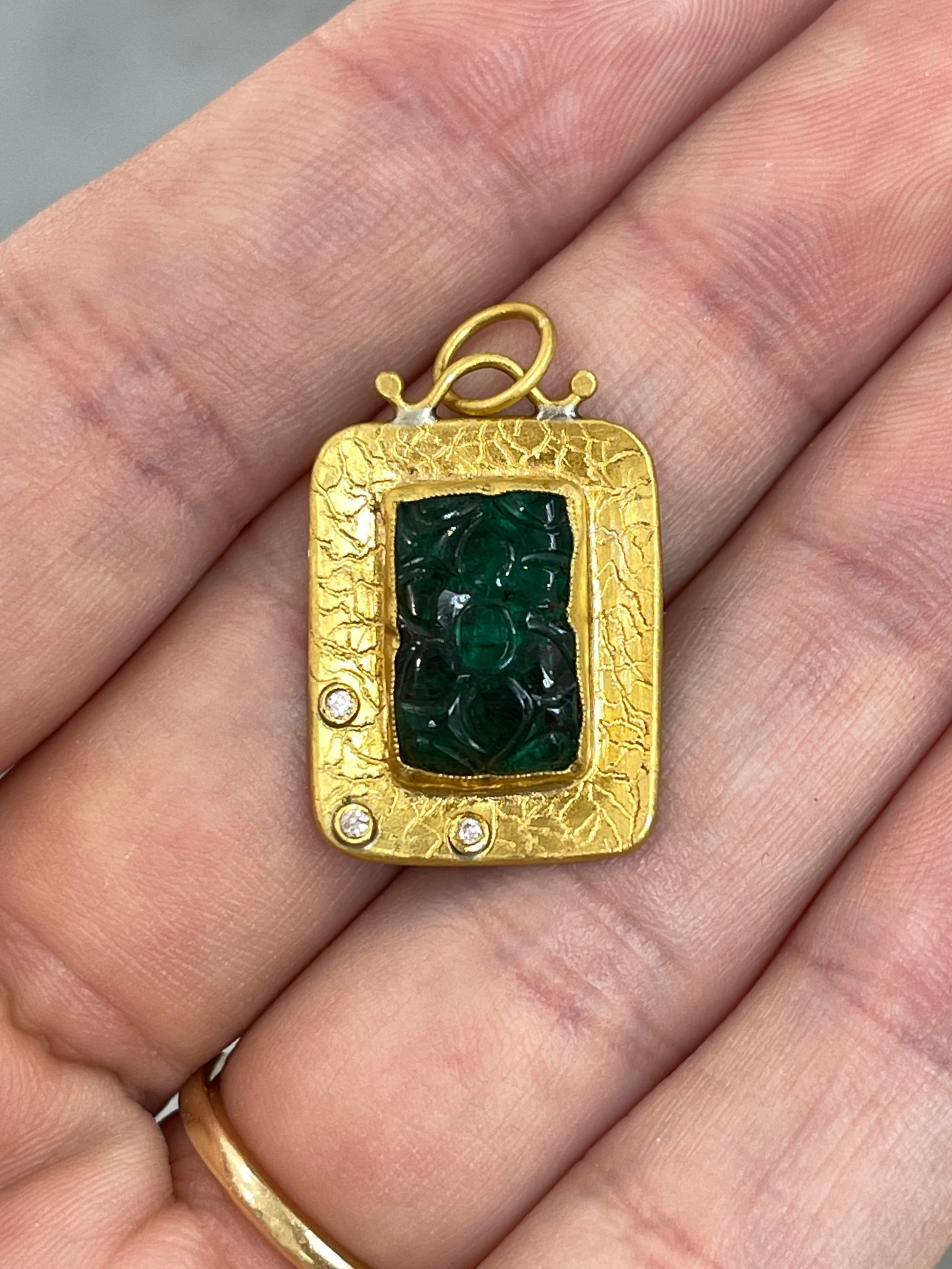 Floral hand-carved emerald and diamond pendant in 24K gold, featuring intricate details and vibrant green color.