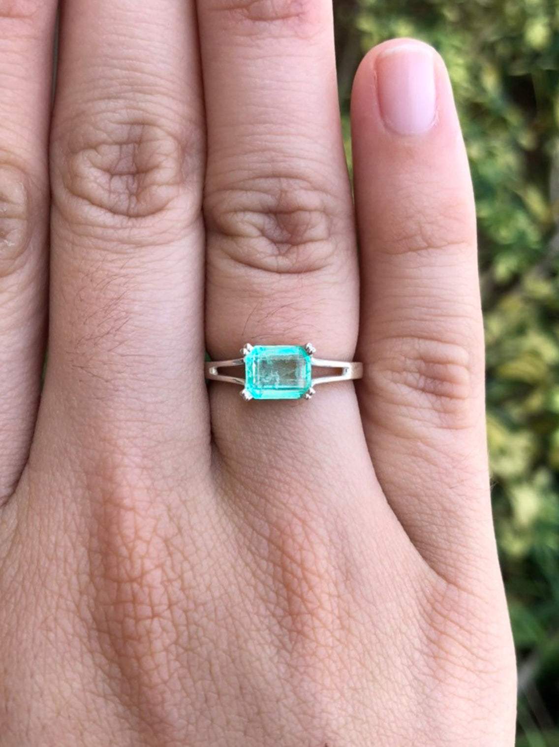 1.25 Carat Emerald Cut Emerald East To West Four Prong Double Shank Ri