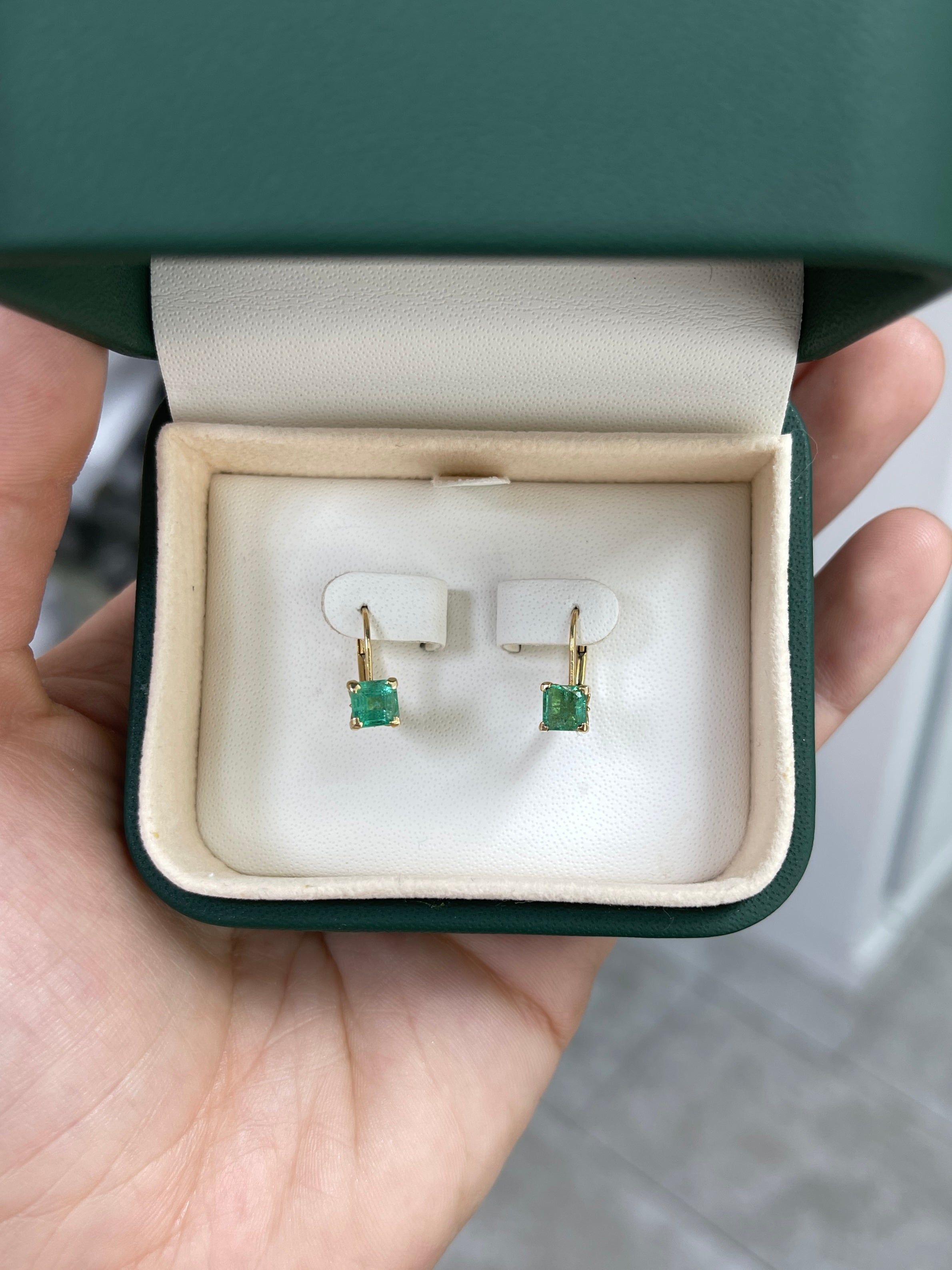 Square emerald leverback earrings with fleur de lis design in 14K gold, featuring 1.44tcw of sparkling emeralds.