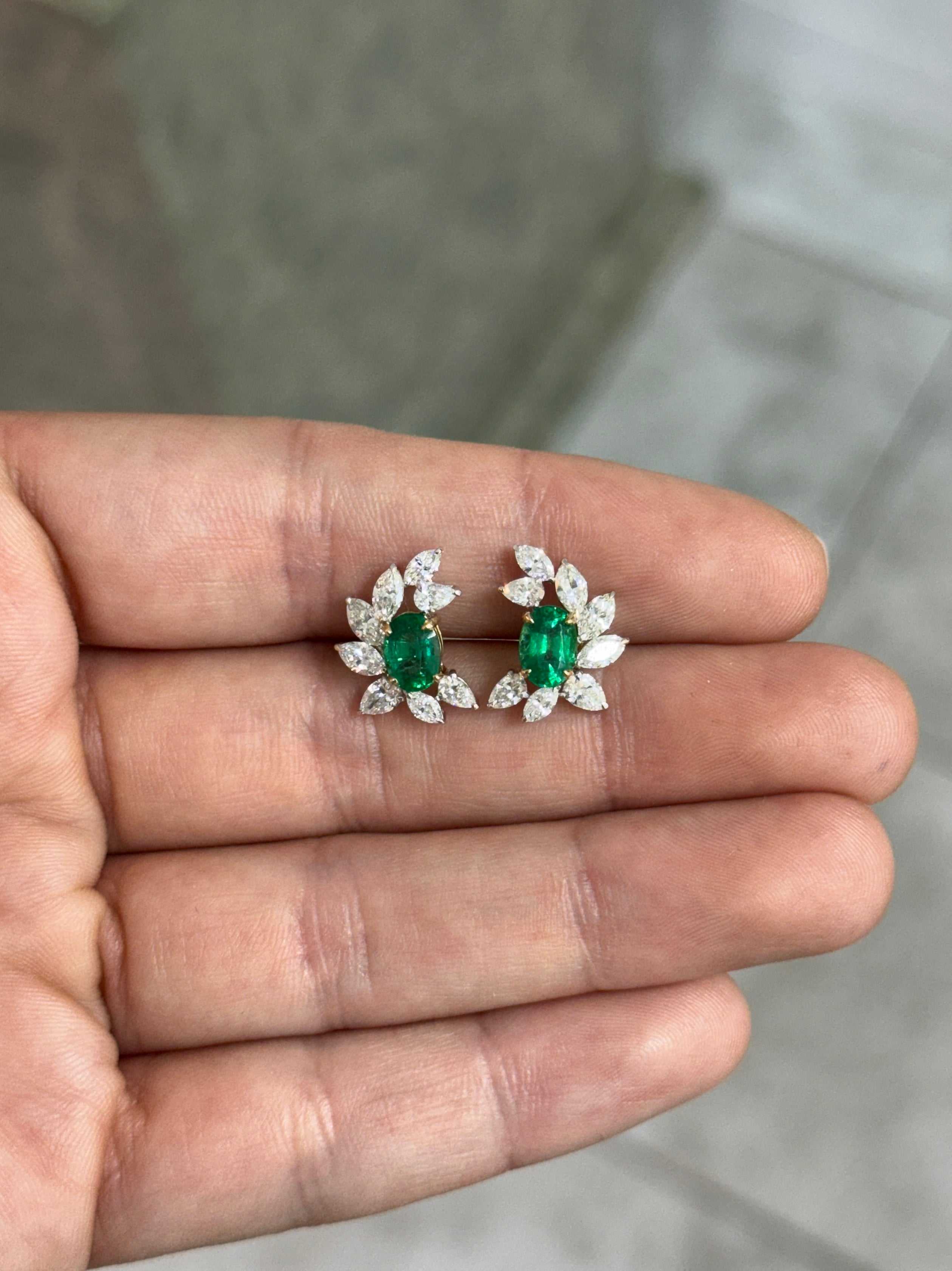 JR Colombian Emeralds 3.69tcw oval emerald and diamond marquise and pear statement stud earrings in 18K gold with intricate design details.
