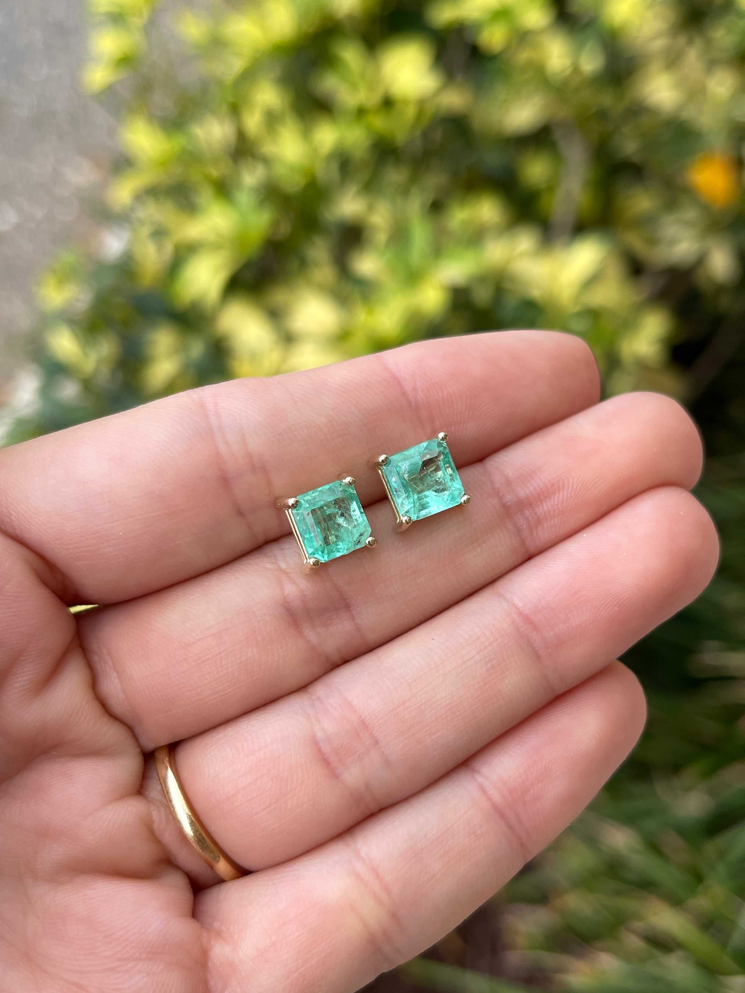 Asscher cut Colombian emerald stud earrings with 3.97tcw earthy spring green gemstones set in 14K gold