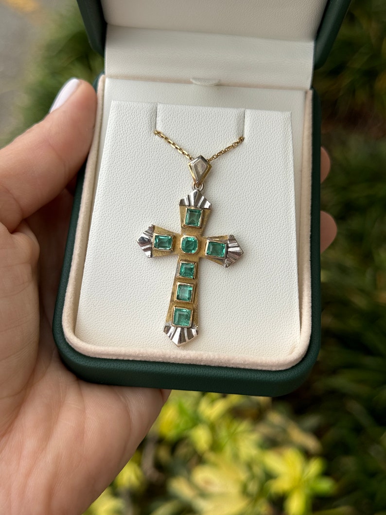 Unisex emerald cross pendant with 2.55tcw natural Colombian emeralds in two-toned 18K yellow and white gold.