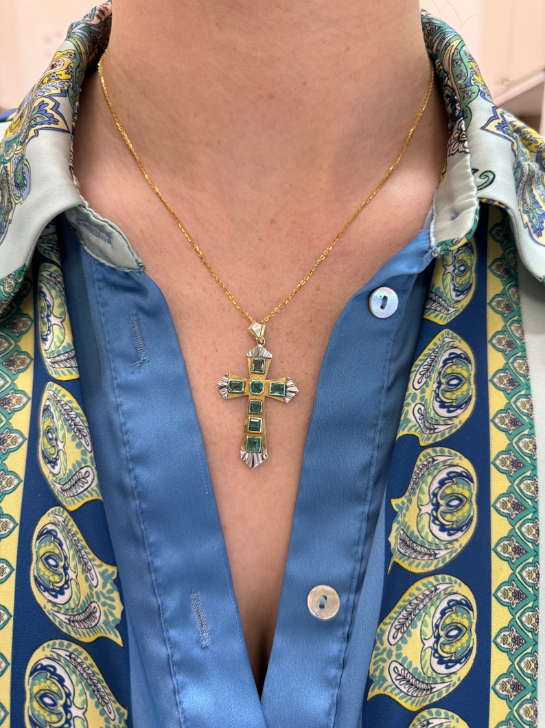 Unisex Colombian Emerald cross pendant with 2.55tcw 18K two-toned yellow and white gold, natural emeralds, detailed craftsmanship.