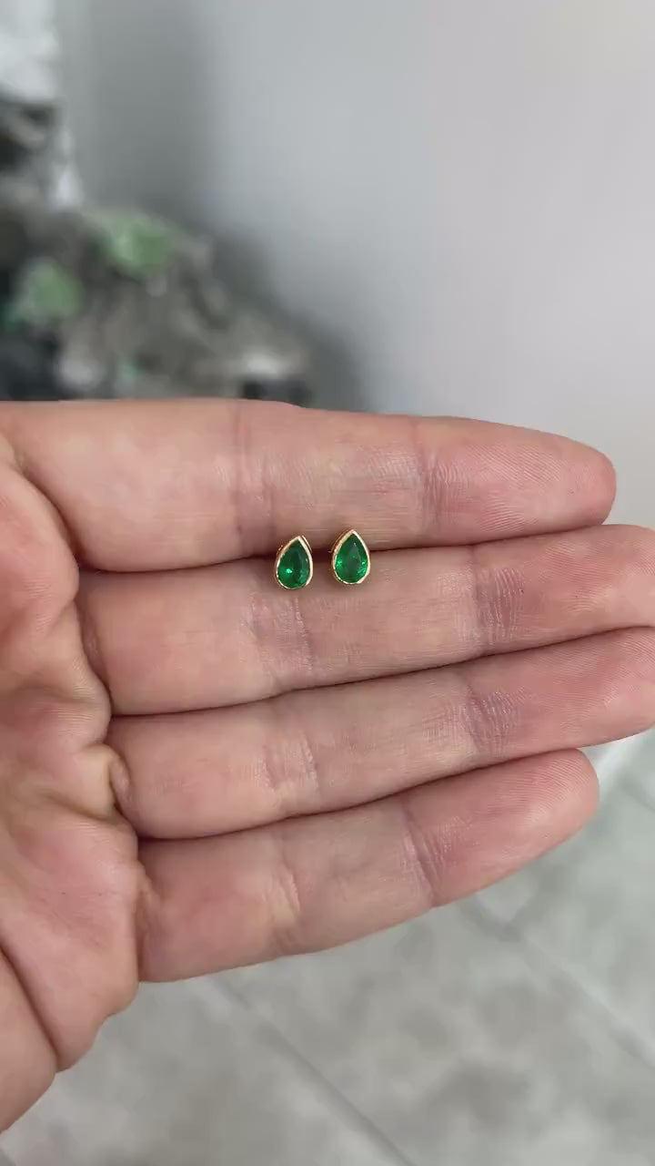 Pear cut Zambian emerald stud earrings in rich green tone, bezel set in 14K gold, 0.68 carats by JR Colombian Emeralds