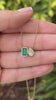 Emerald moissanite toi et moi pendant necklace with 14K yellow gold setting  showcasing two sparkling gemstones, by JR Colombian Emeralds