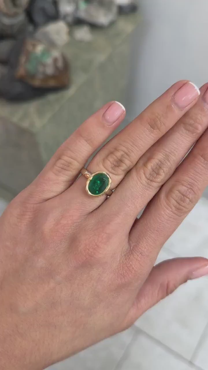 3.85ct oval emerald solitaire ring in two-tone 14K gold with sleek bezel setting