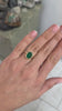 3.85ct oval emerald solitaire ring in two-tone 14K gold with sleek bezel setting