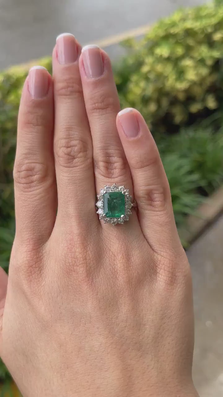 Stunning 6.64tcw Deep Green Emerald Ring Surrounded by a Diamond Halo in 14K Gold