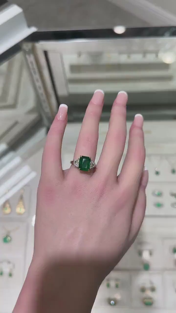 18K Platinum Three-Stone Ring Featuring 4.79tcw Dark Green VVS2 Emerald and Diamonds