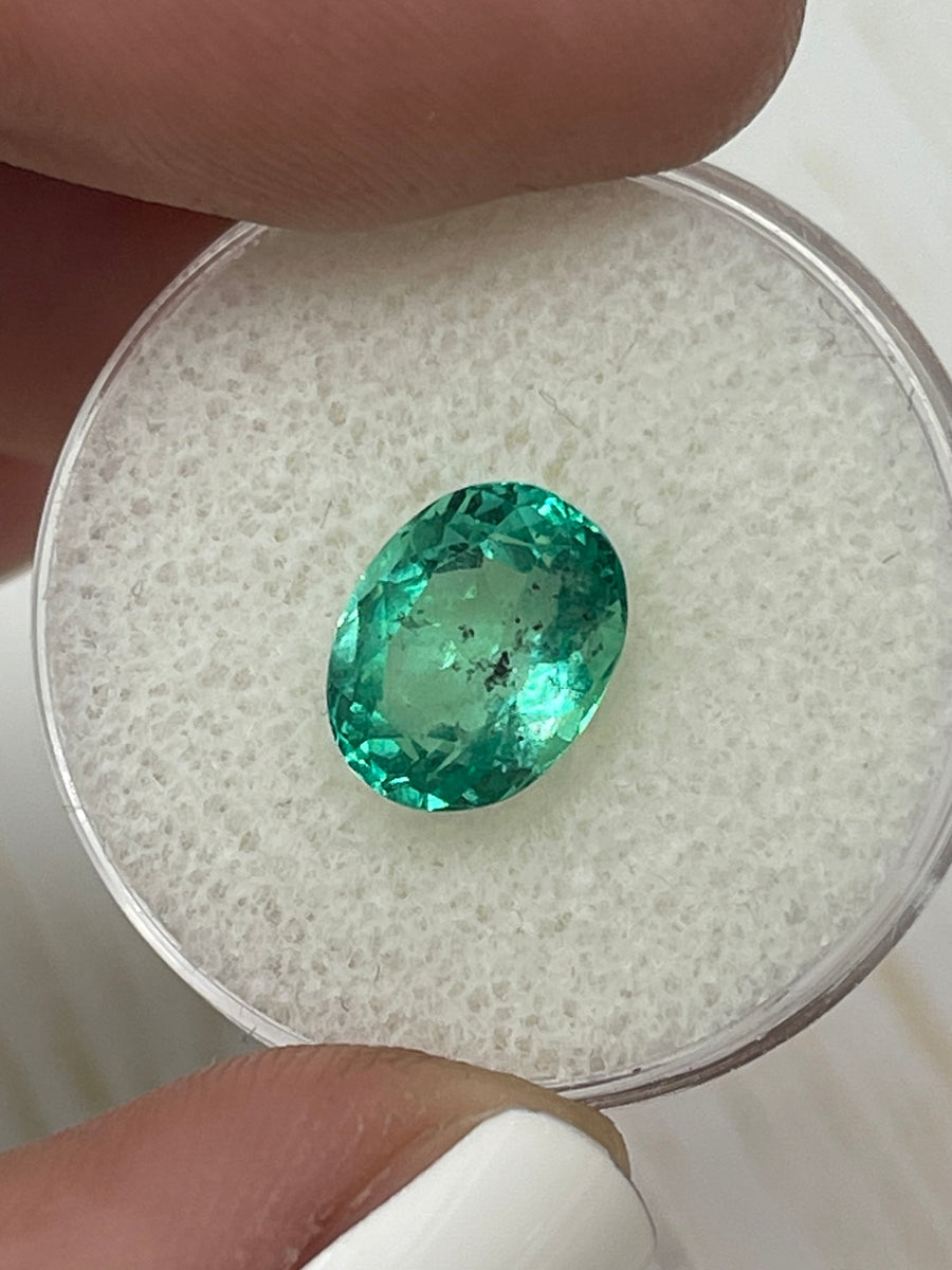 Vivid 2.83 Carat Loose Colombian Emerald - Oval Shaped and Adorned with Natural Green Speckles