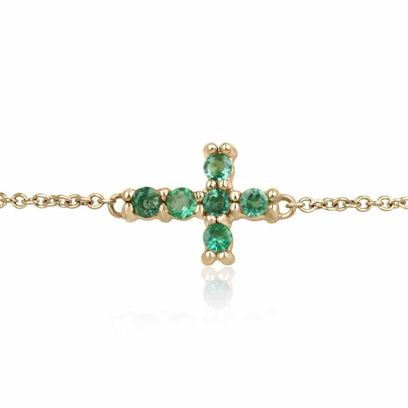 14K yellow gold cross bracelet with round-cut vivid medium green natural emeralds, 0.20 tcw, from Colombian Emerald.