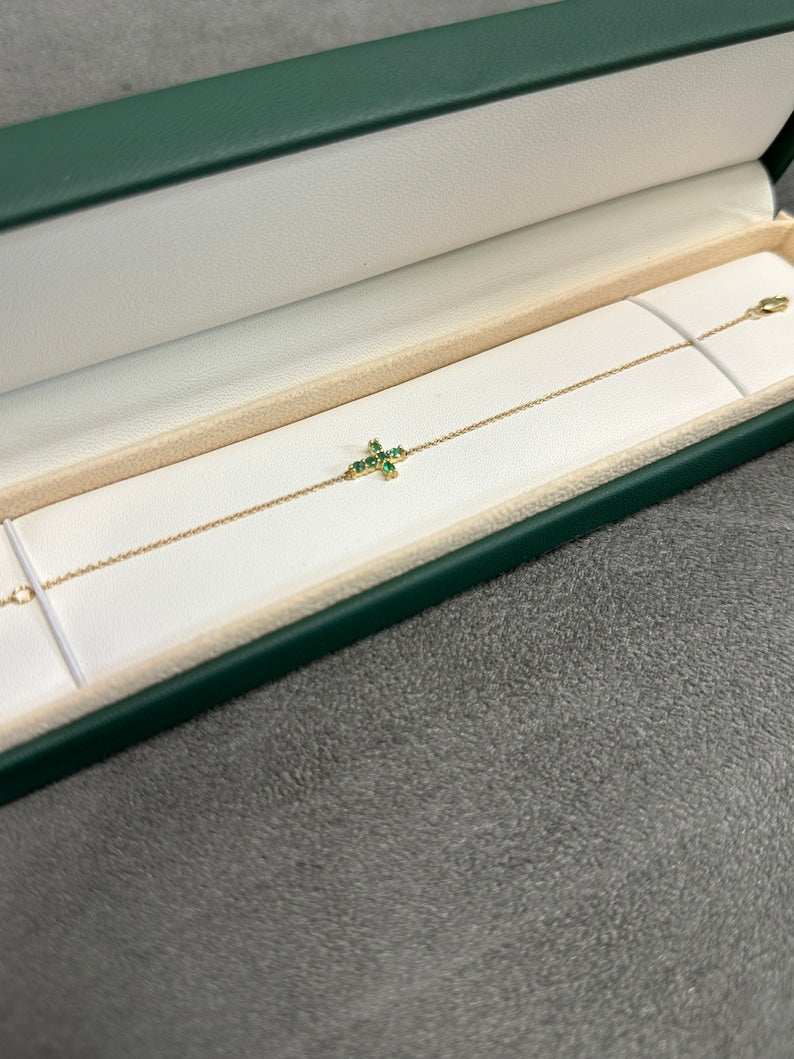 14K gold green emerald cross bracelet with round cut vivid medium green natural emeralds, Colombian Emerald brand.
